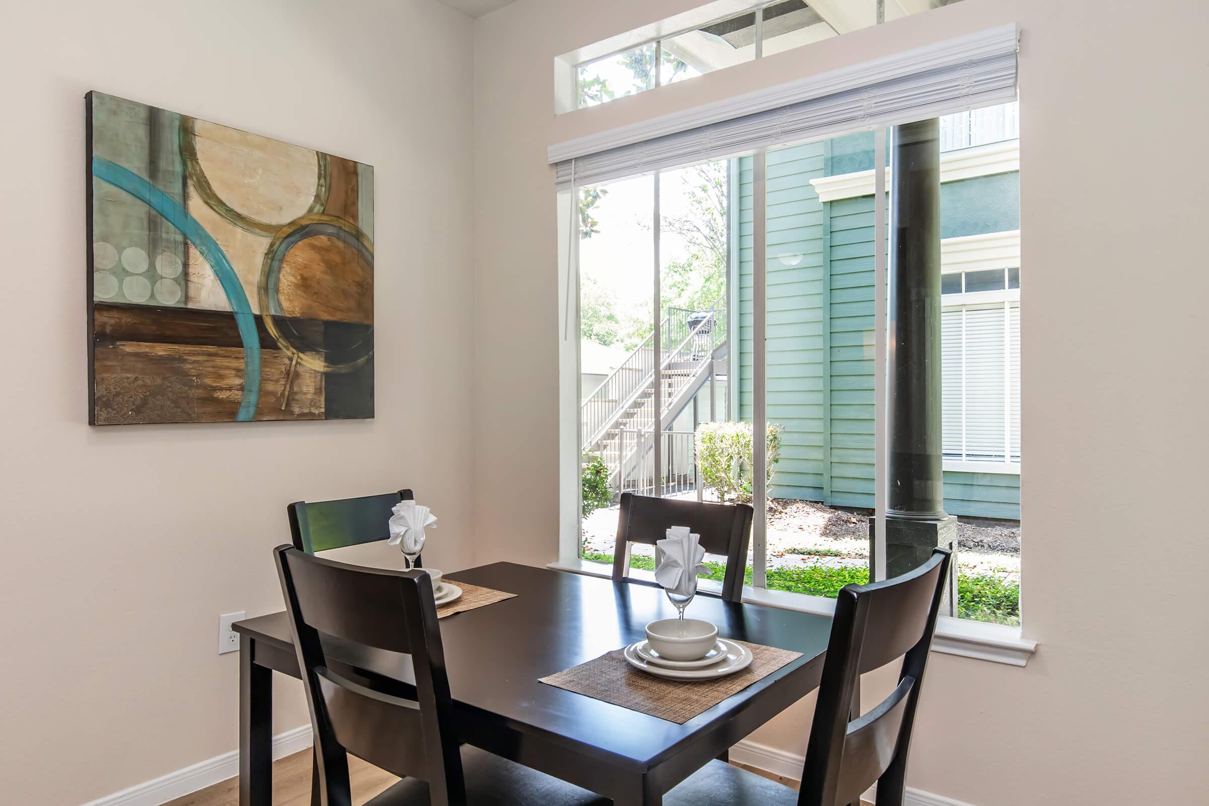 a dining room table in front of a window