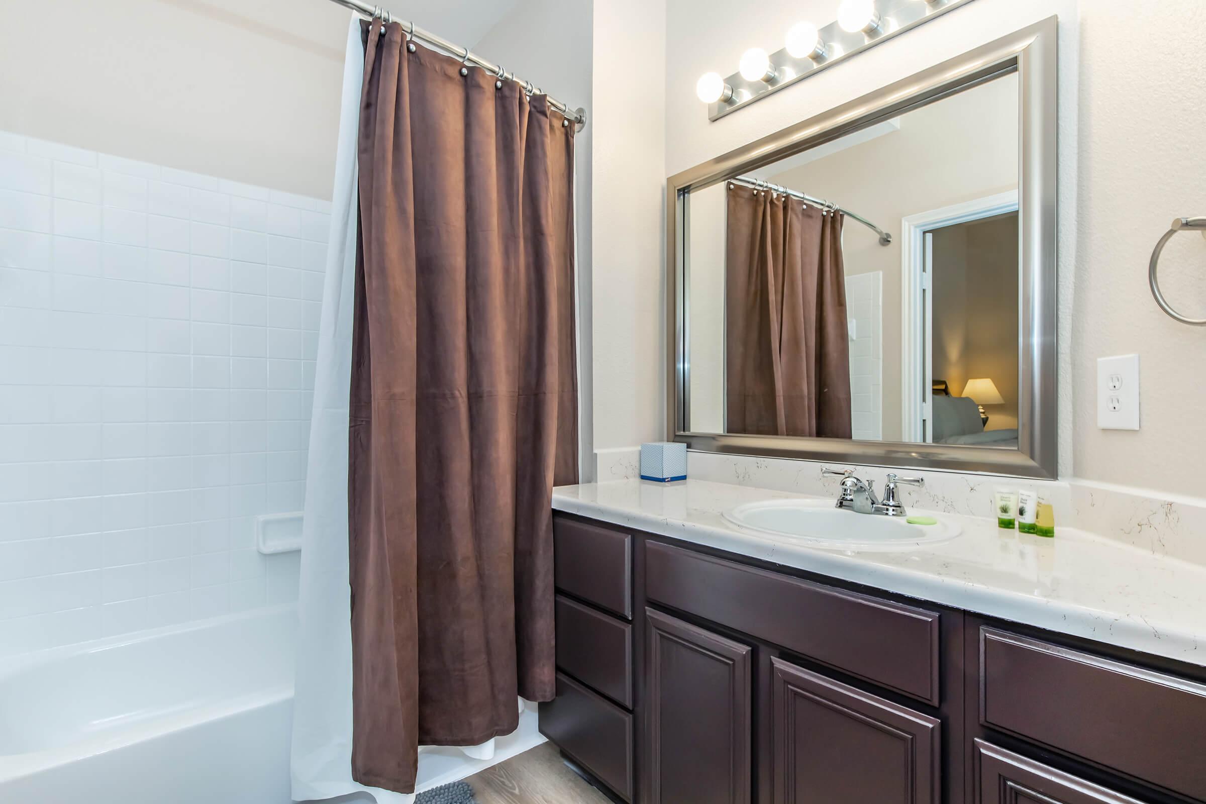 a shower curtain next to a sink