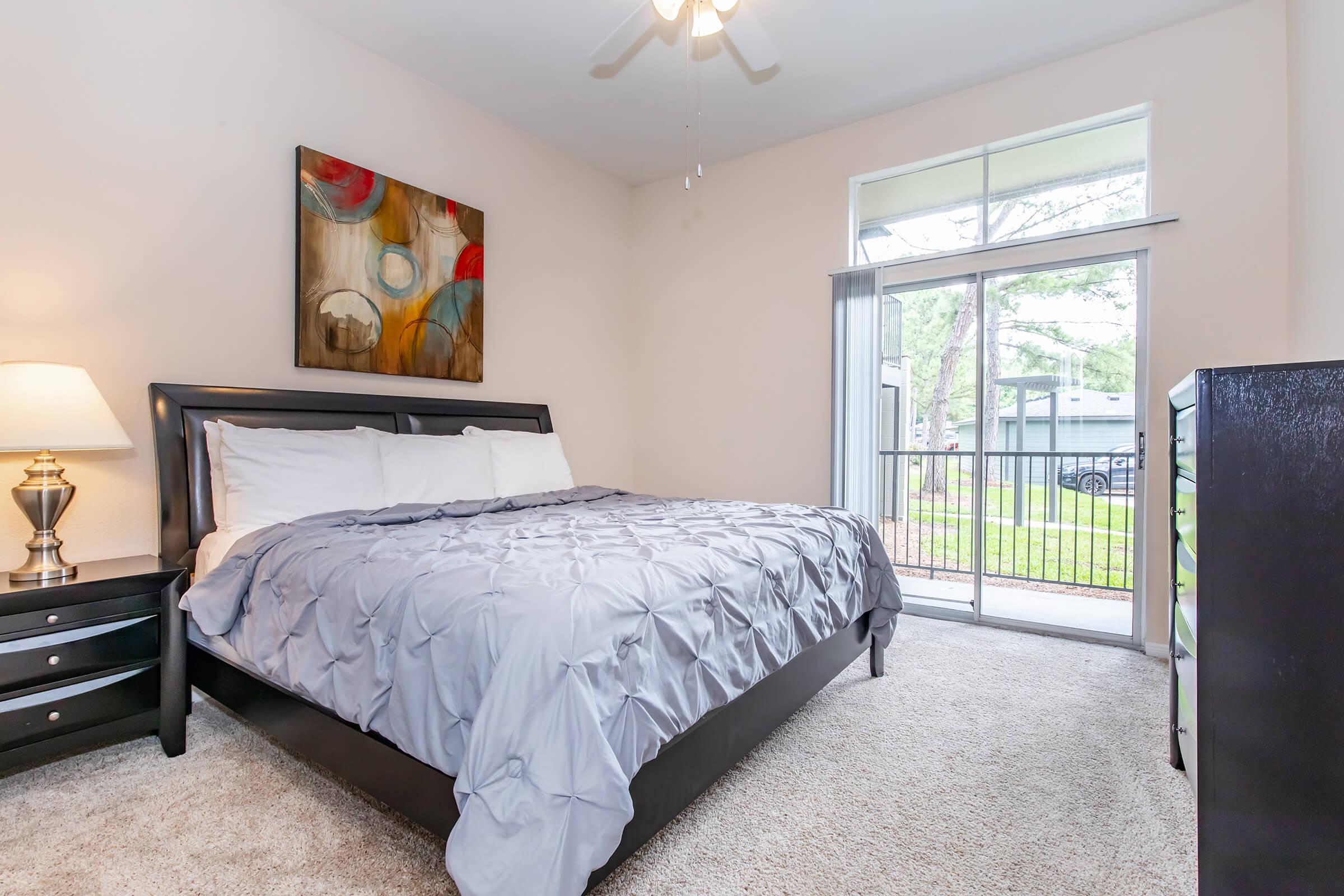 a bedroom with a bed and desk in a room