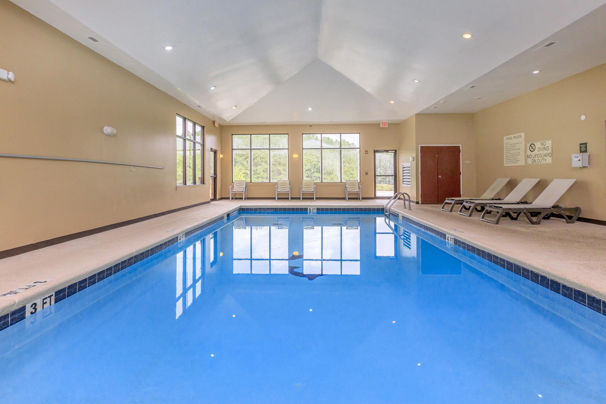 a large empty room with a pool table