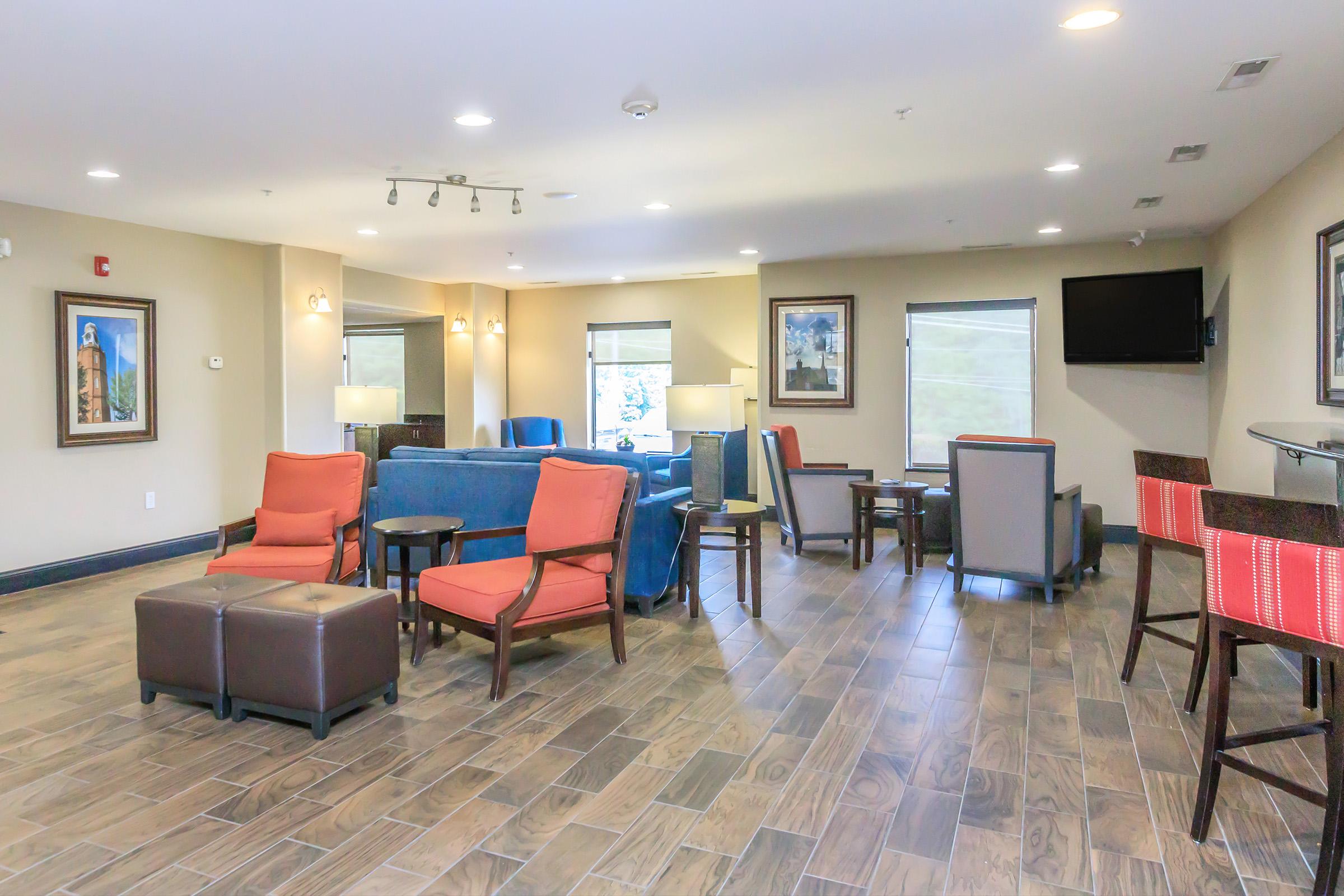 a living room filled with furniture and a tv