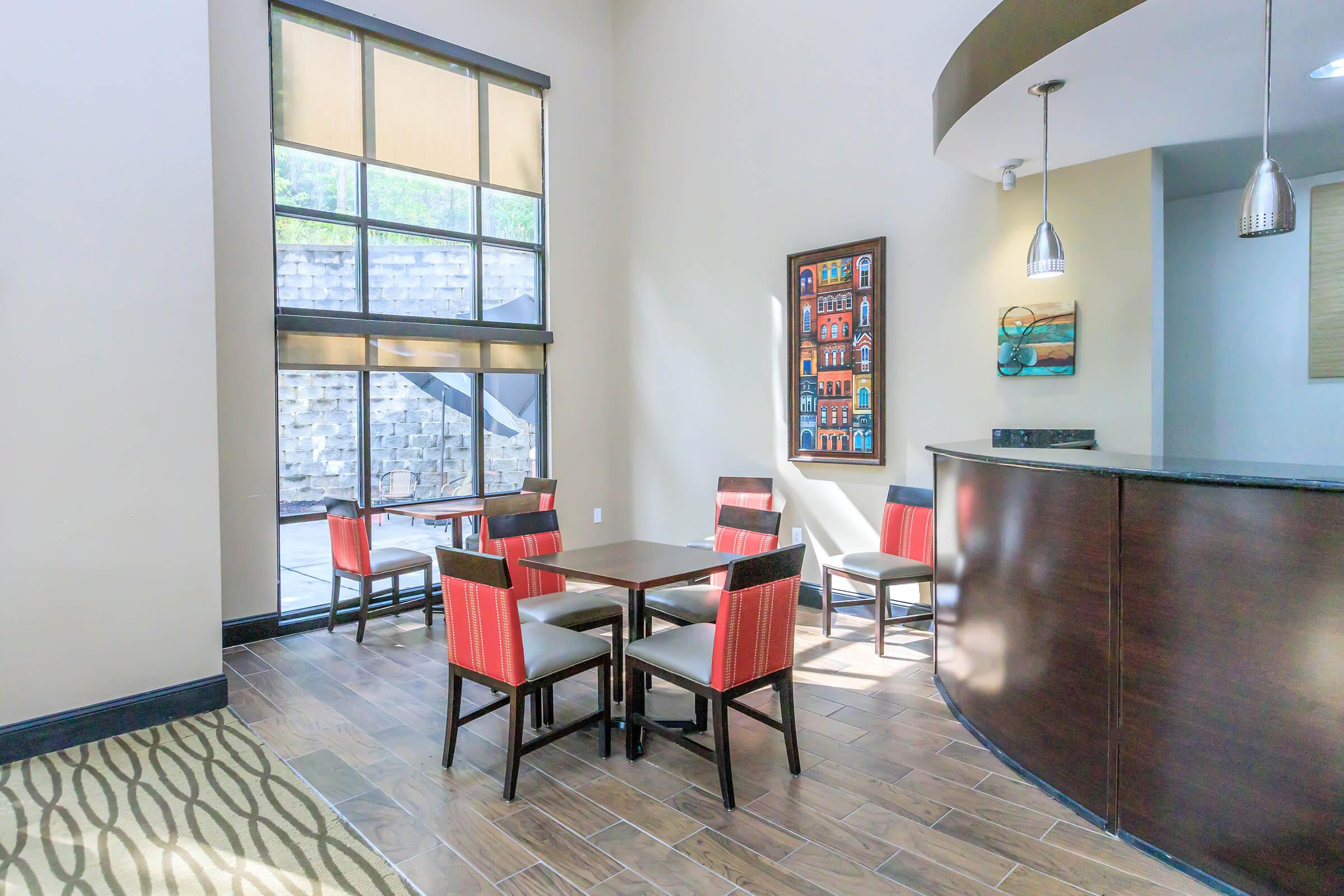 a living room filled with furniture and a large window