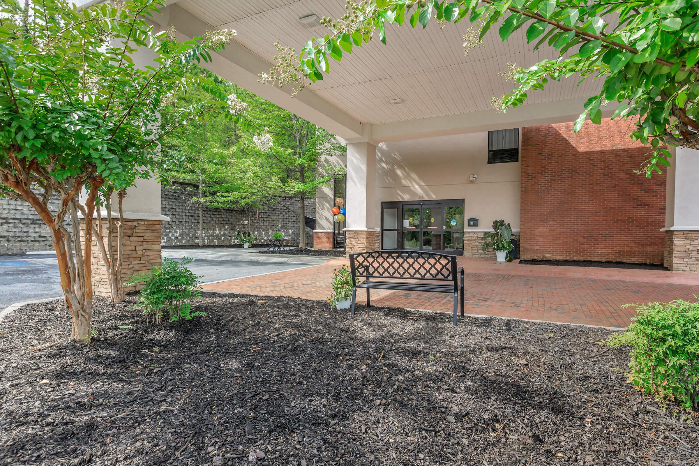 a house with bushes in front of a building