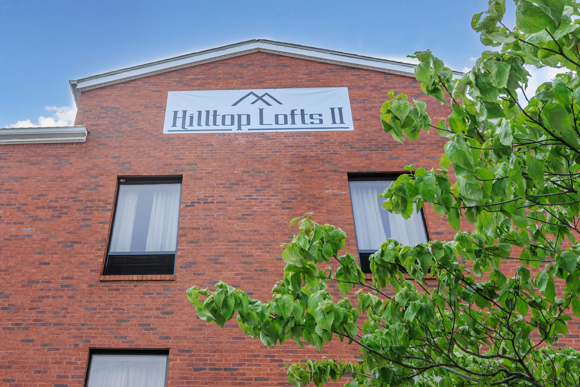 a sign in front of a brick building