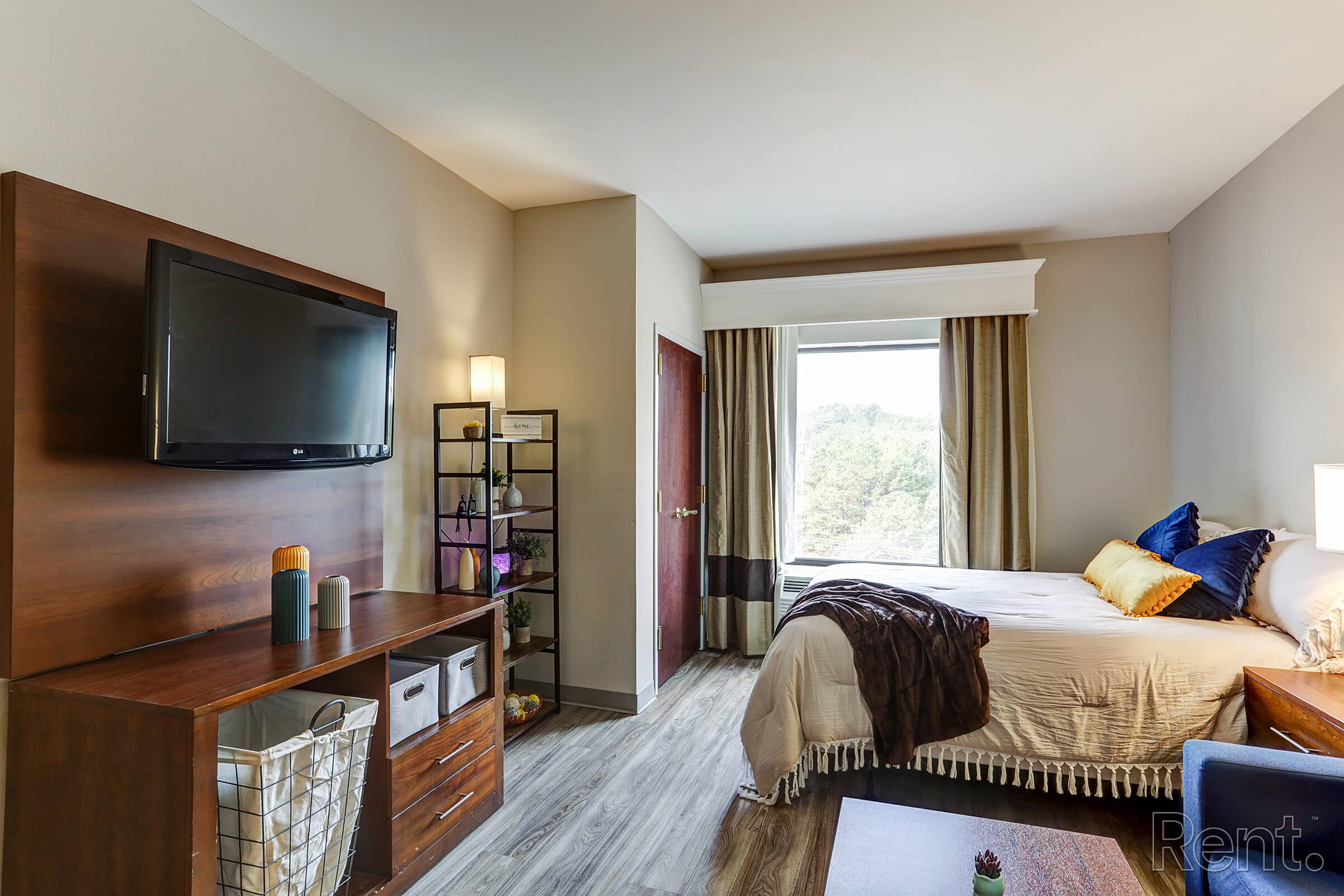 a bedroom with a large bed in a hotel room