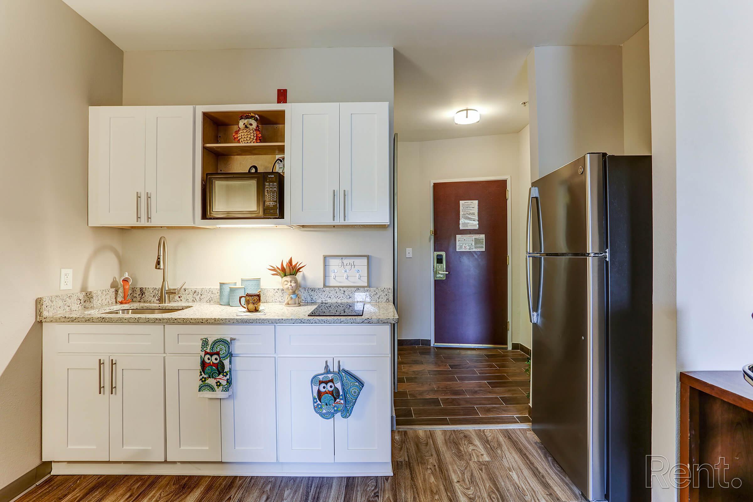 a kitchen with a sink and a refrigerator