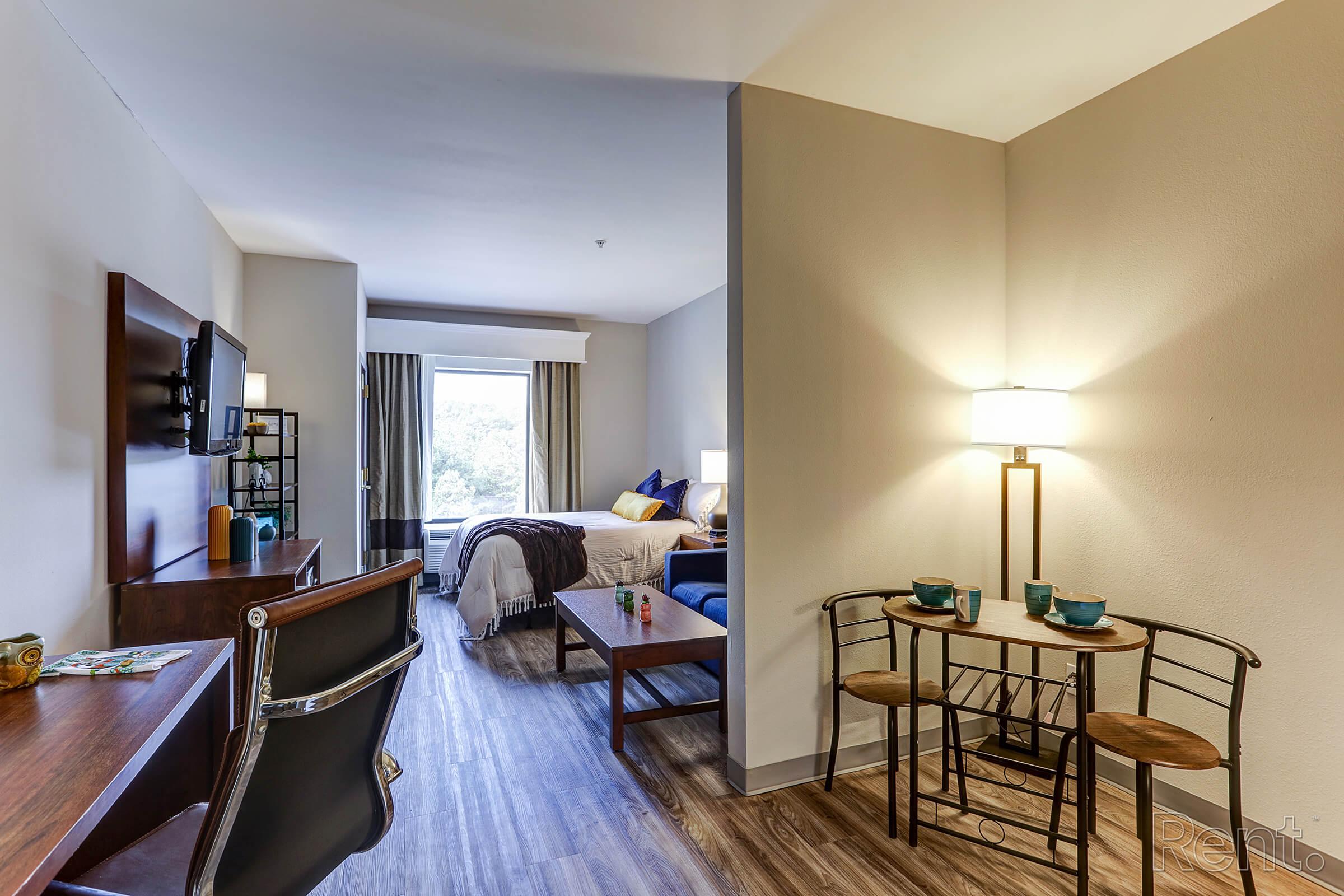 a living room filled with furniture and a bed