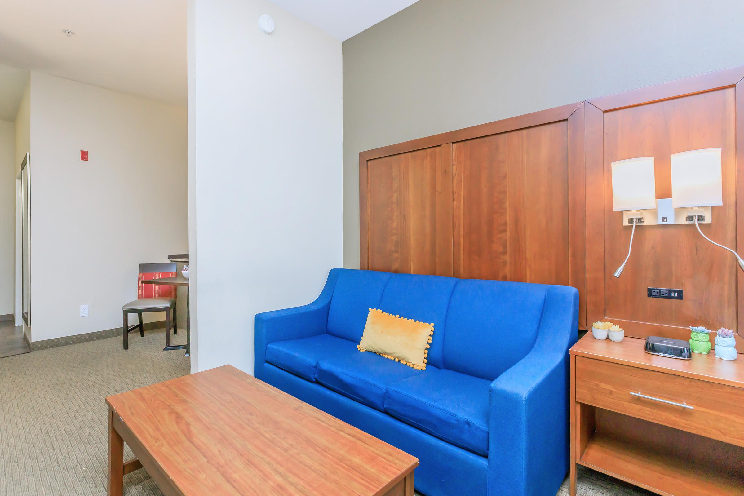 a living room filled with furniture and a blue sky