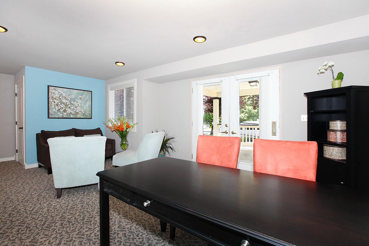 a living room filled with furniture and a flat screen tv