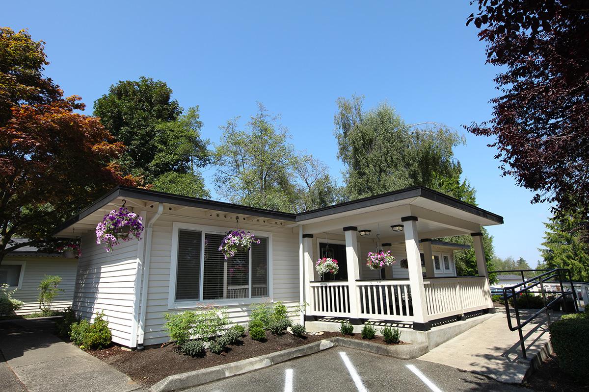 a house with bushes in front of a building