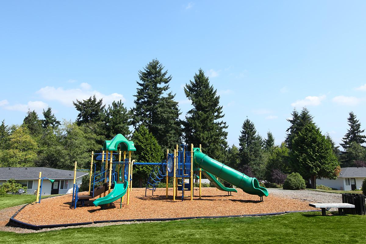 a playground in front of a green field