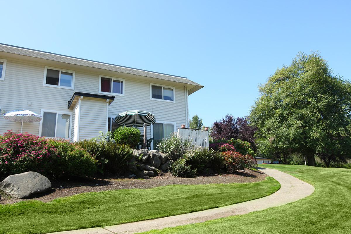 a house with bushes in front of a building