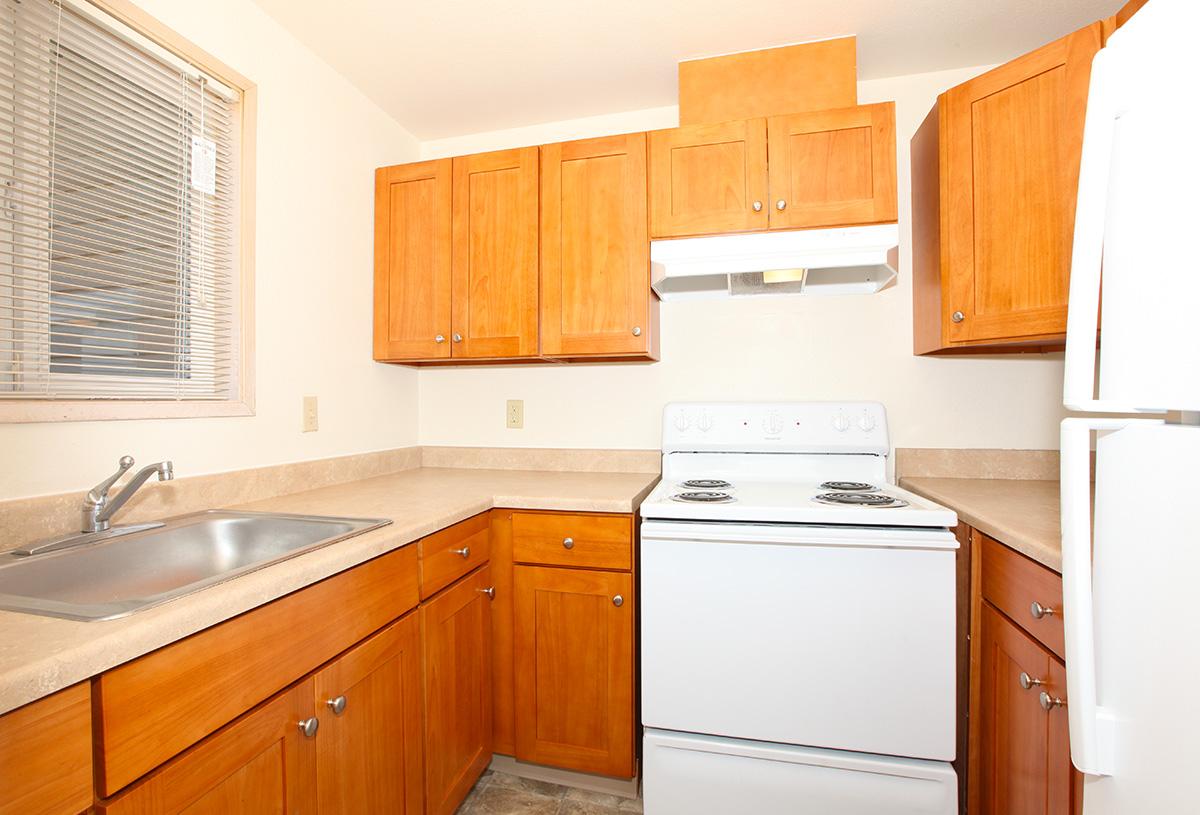 a kitchen with wooden cabinets and a microwave