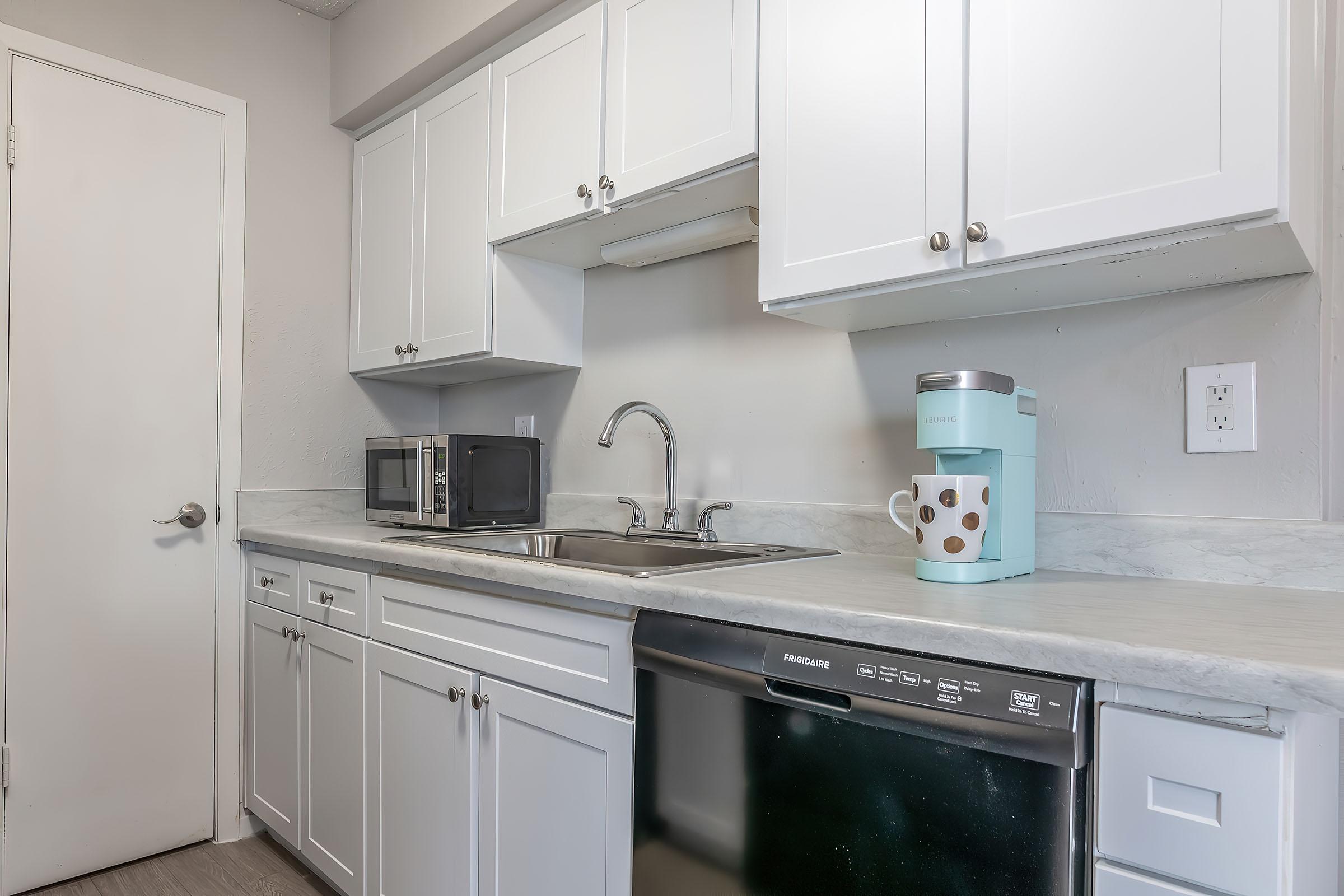 a kitchen with a stove a sink and a microwave