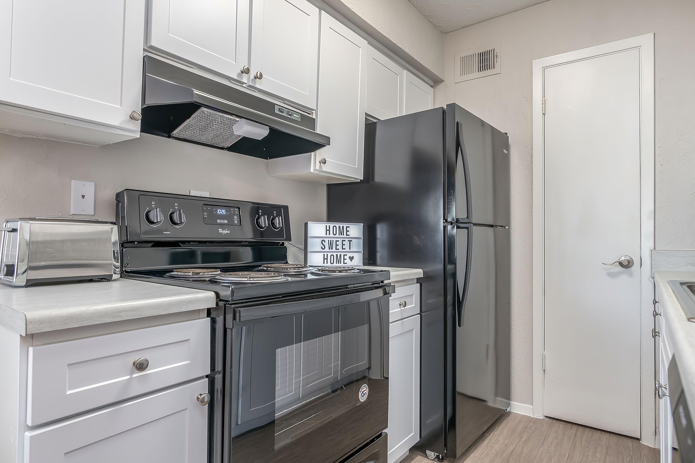 a kitchen with a stove top oven sitting inside of a refrigerator