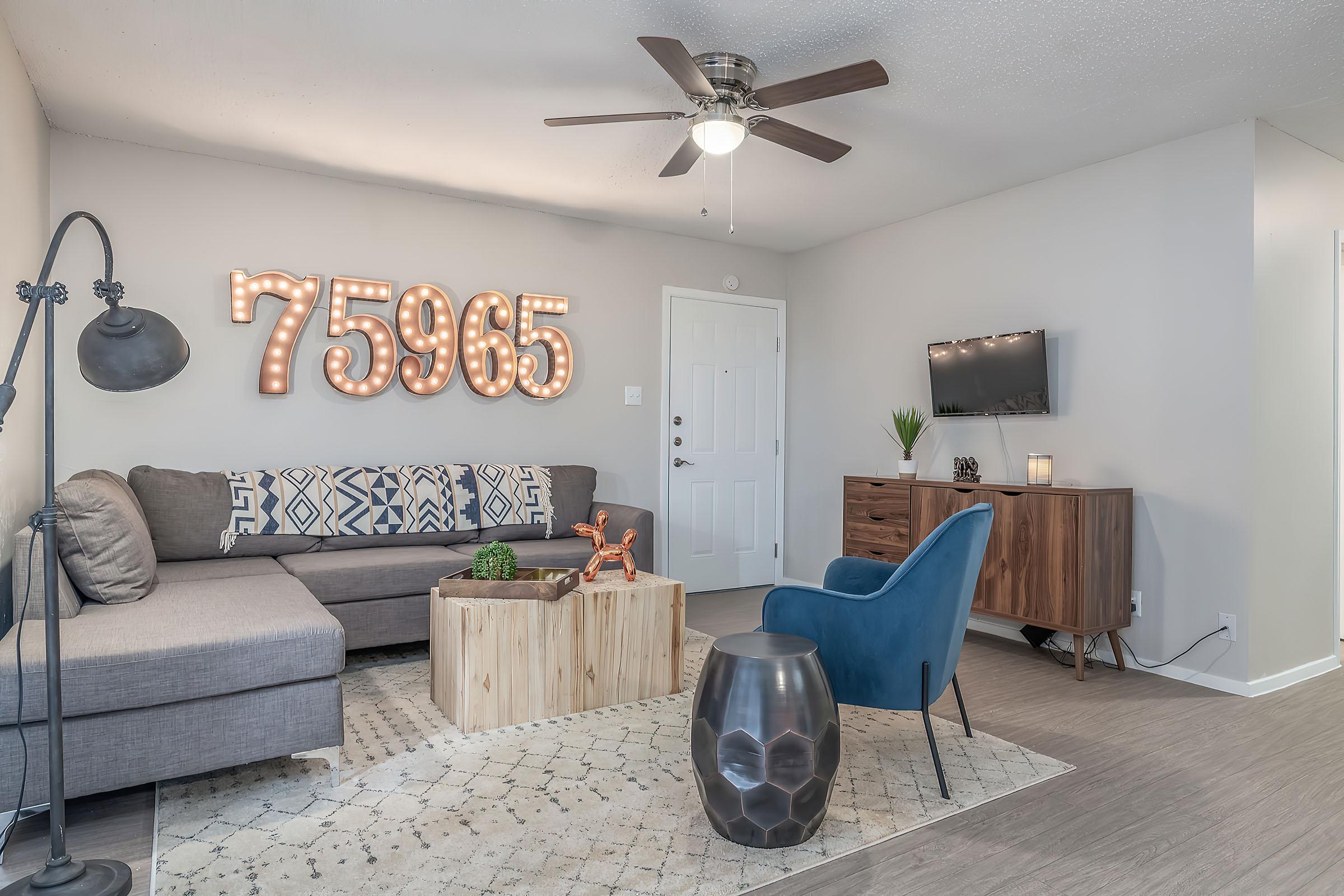 a living room filled with furniture and a tv