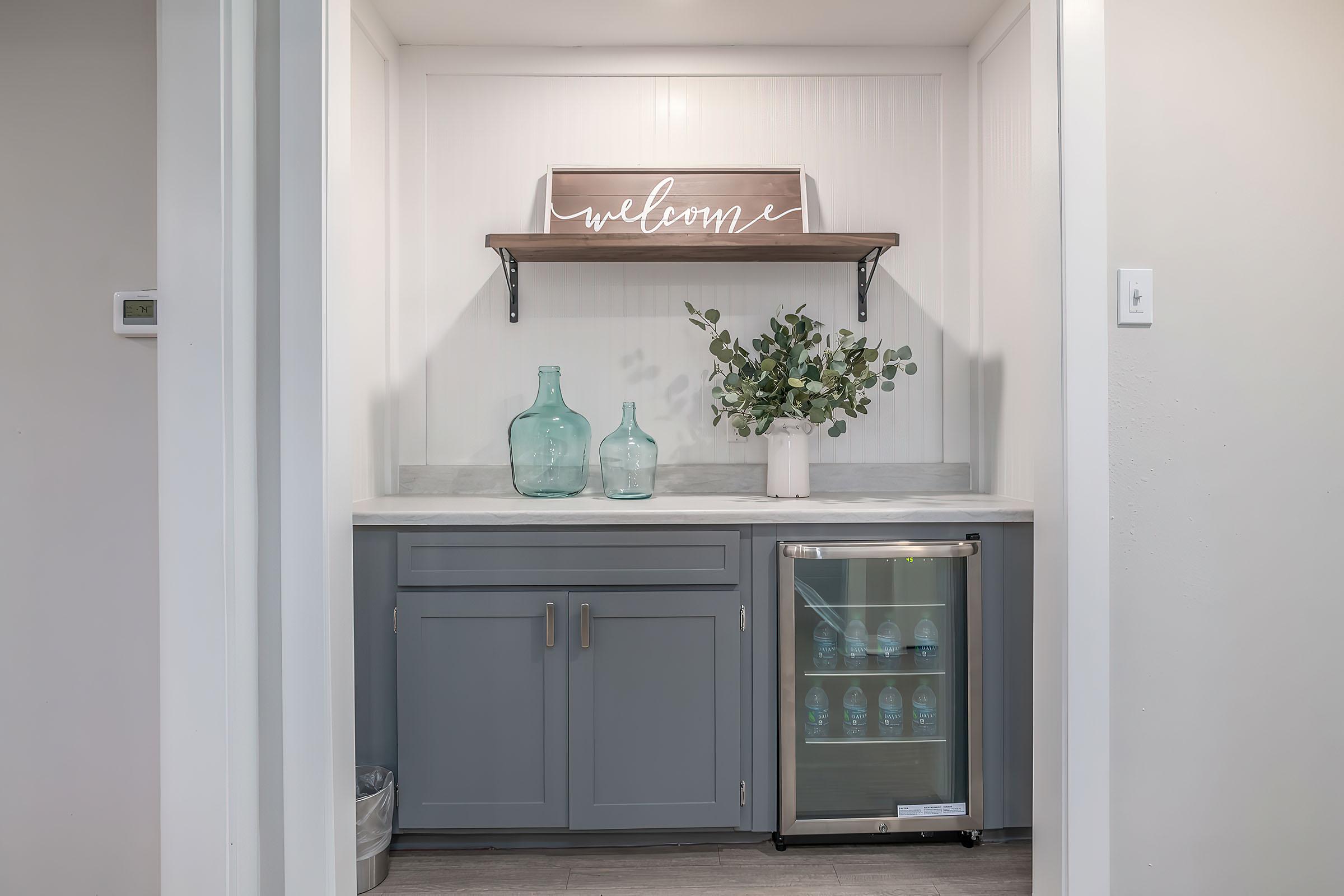 a kitchen with a sink and a mirror