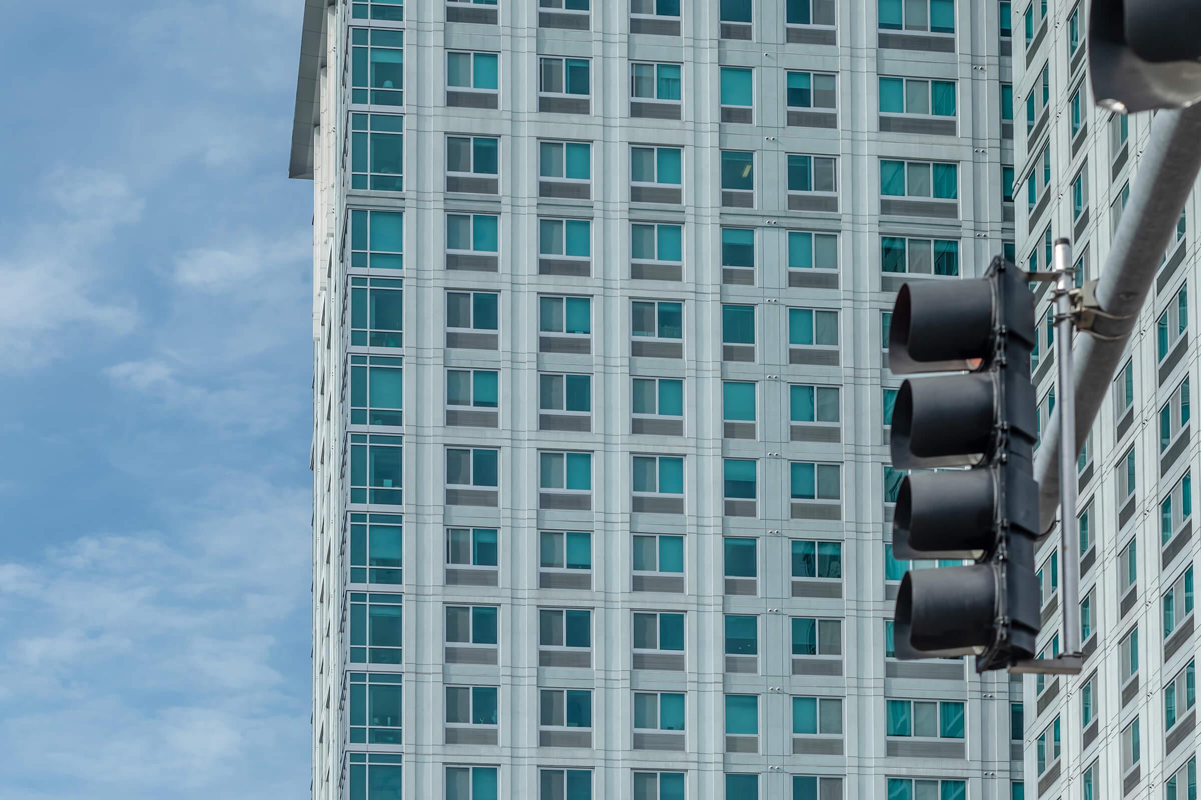 a traffic light sitting below a tall building