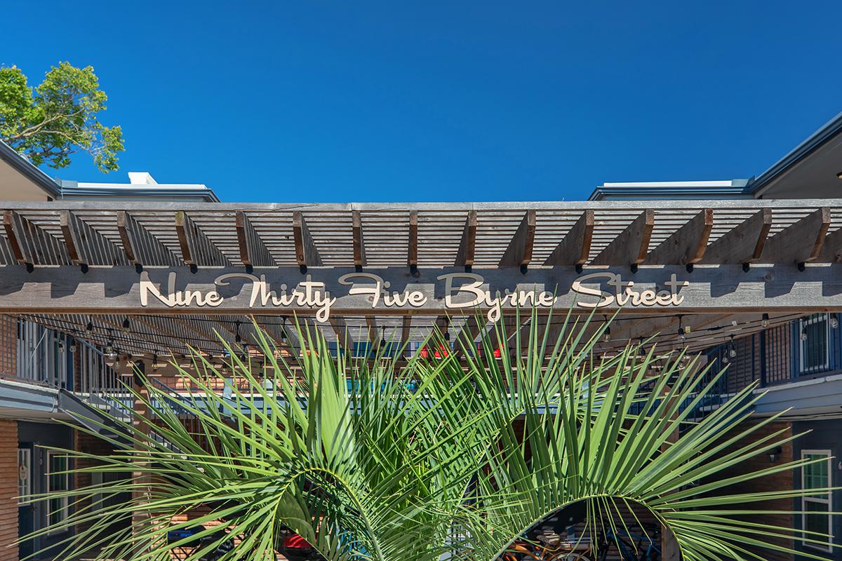 a group of palm trees on the side of a building