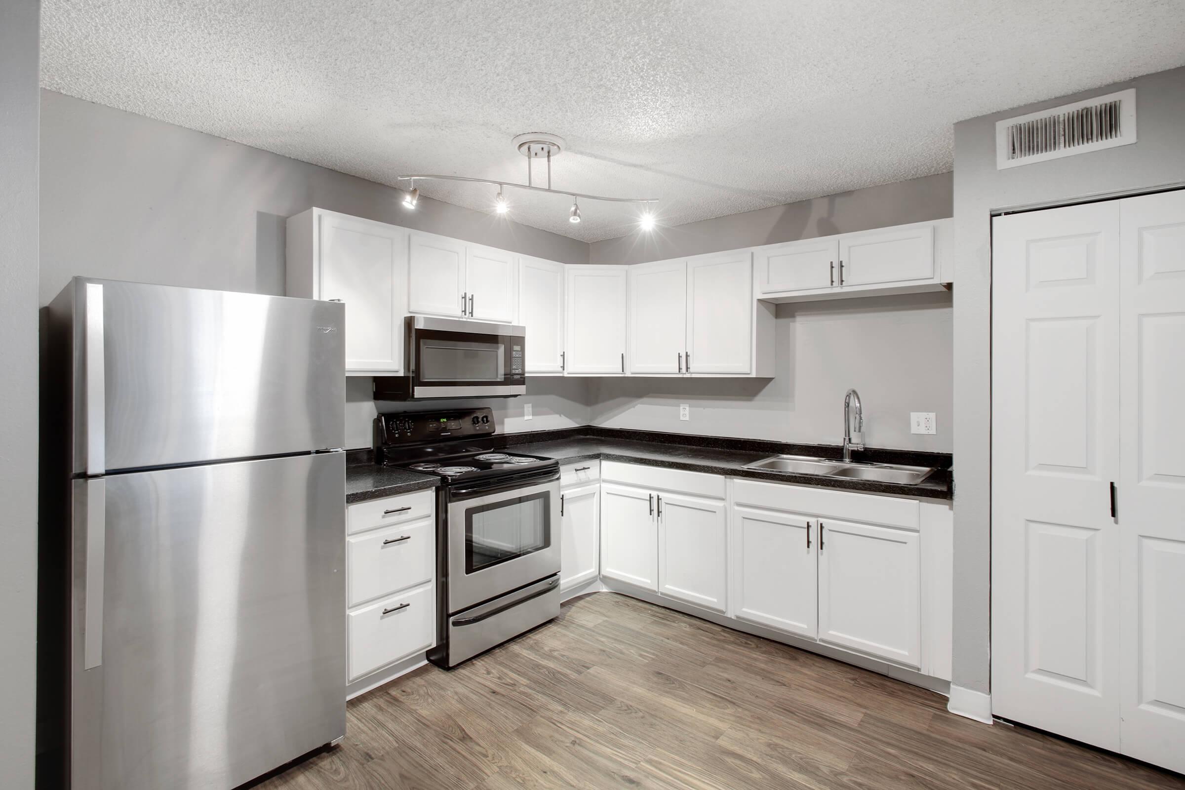 a kitchen with a stove and a refrigerator