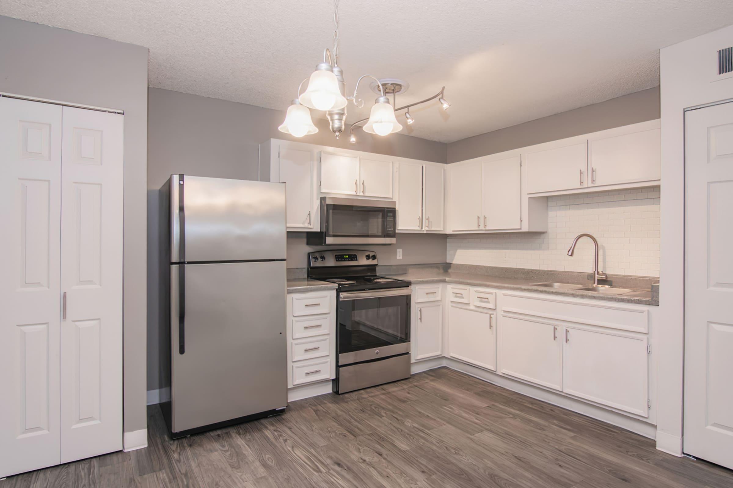 a kitchen with a stove and a refrigerator