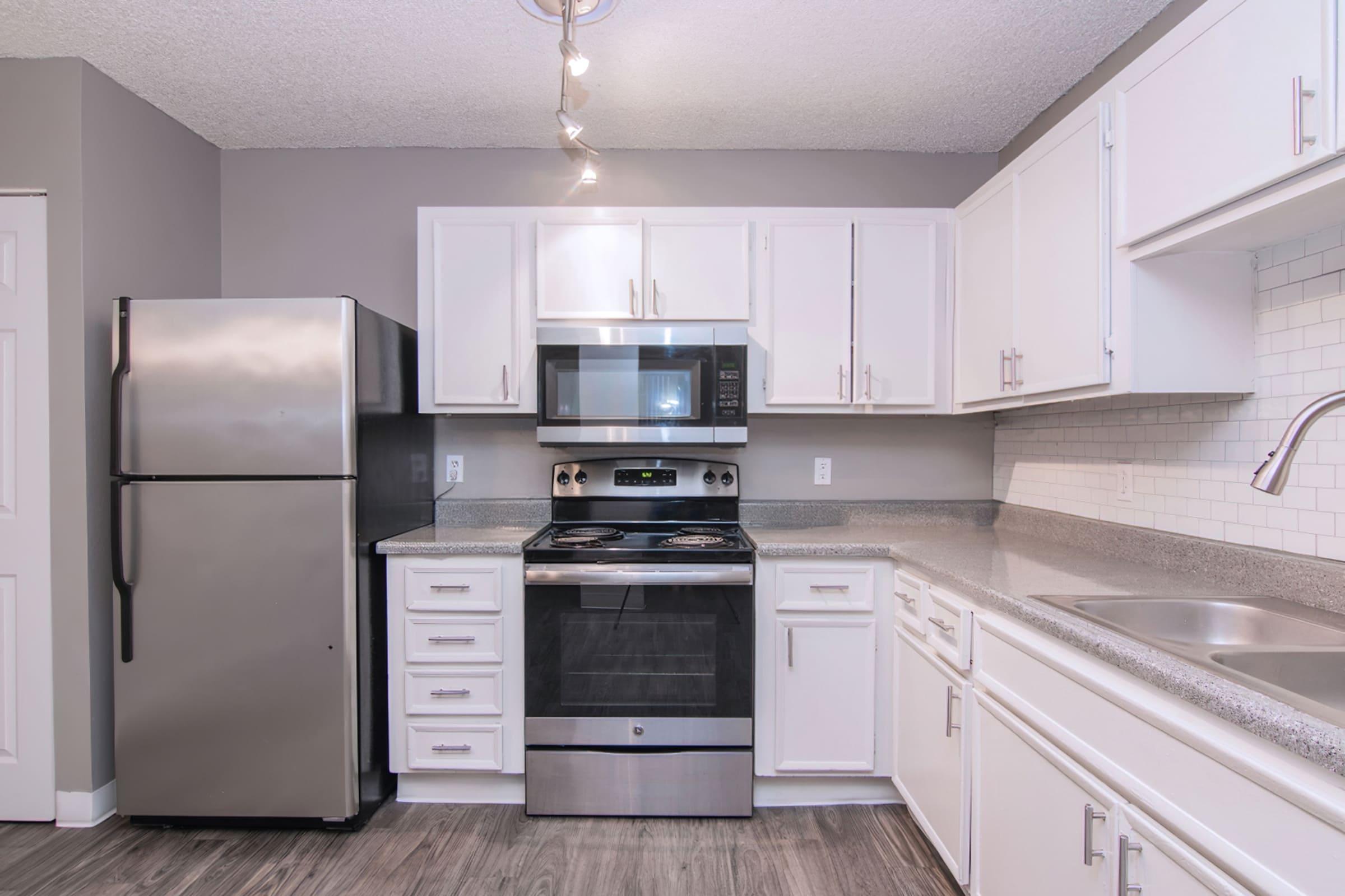 a kitchen with a stove and a refrigerator