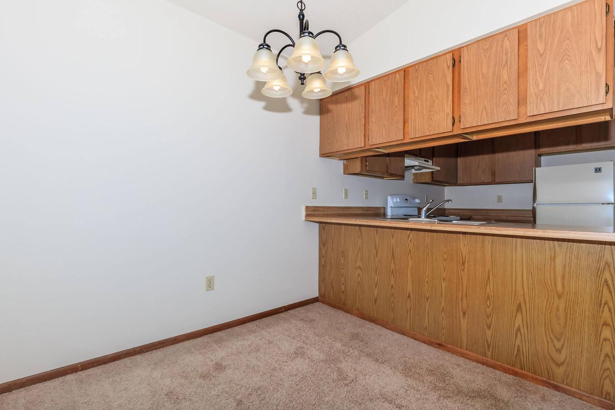 a kitchen with wooden cabinets