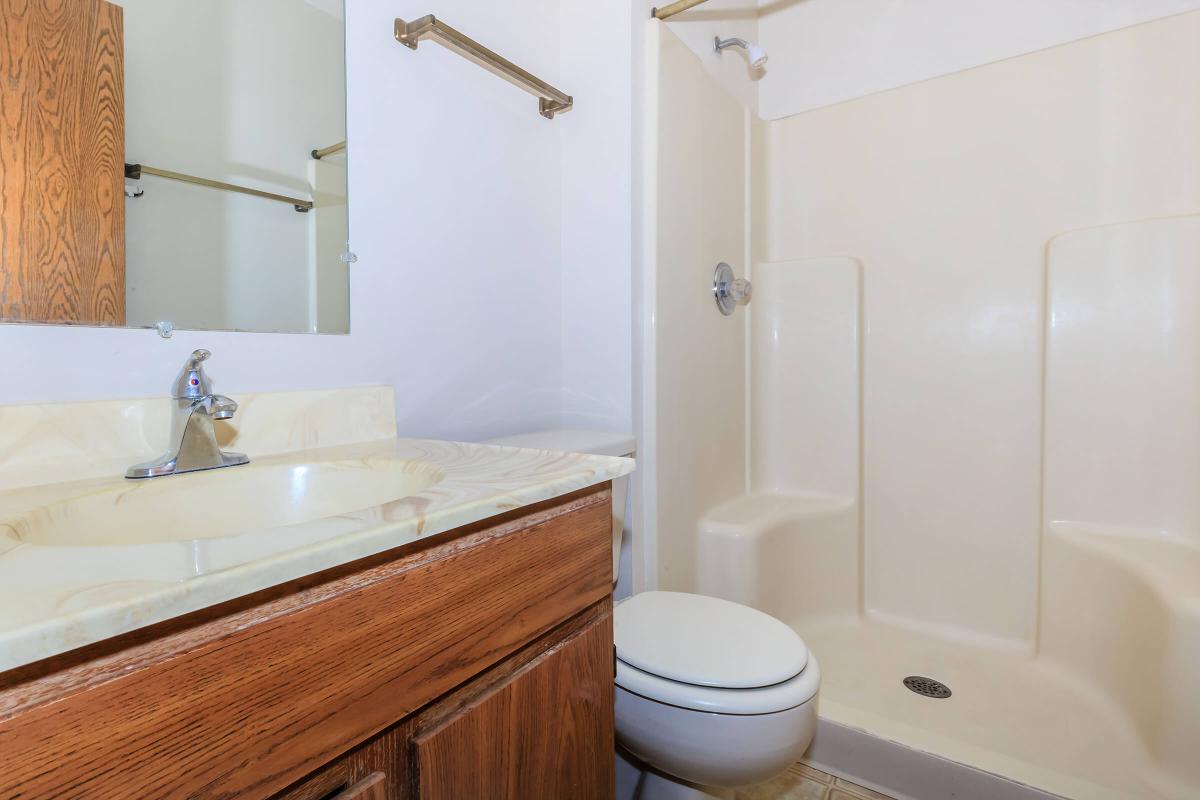a white tub sitting next to a shower