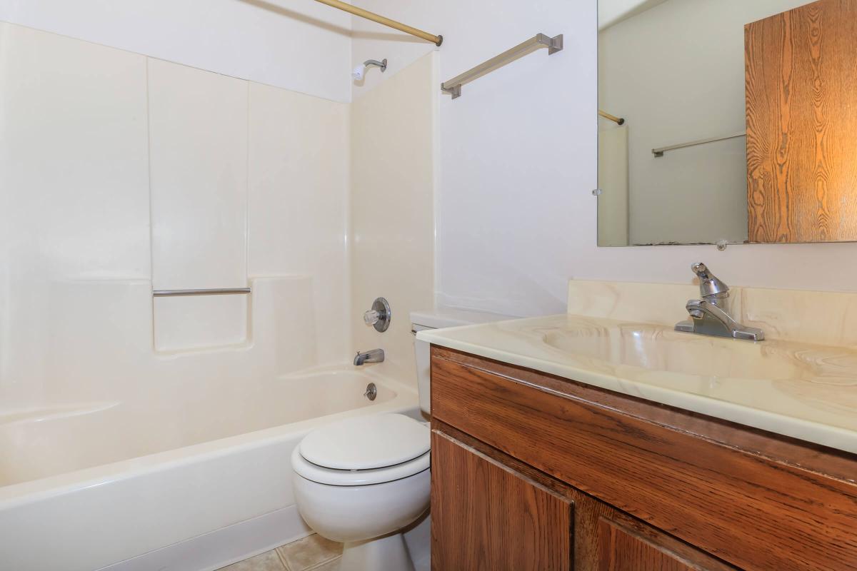 a large white tub sitting next to a sink