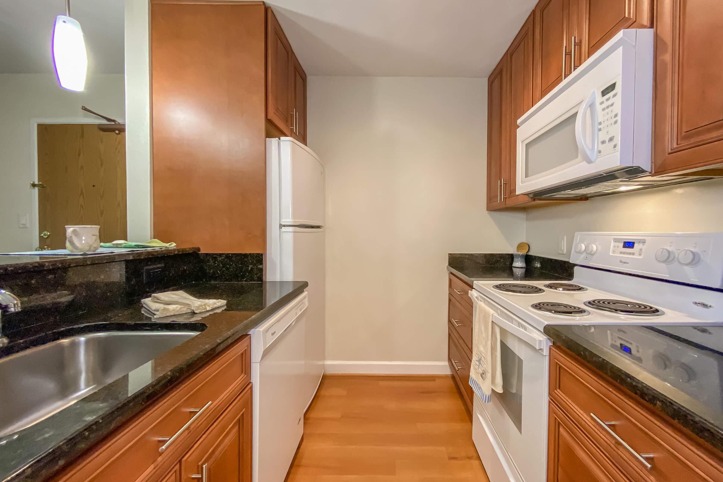 a modern kitchen with stainless steel appliances and wooden cabinets