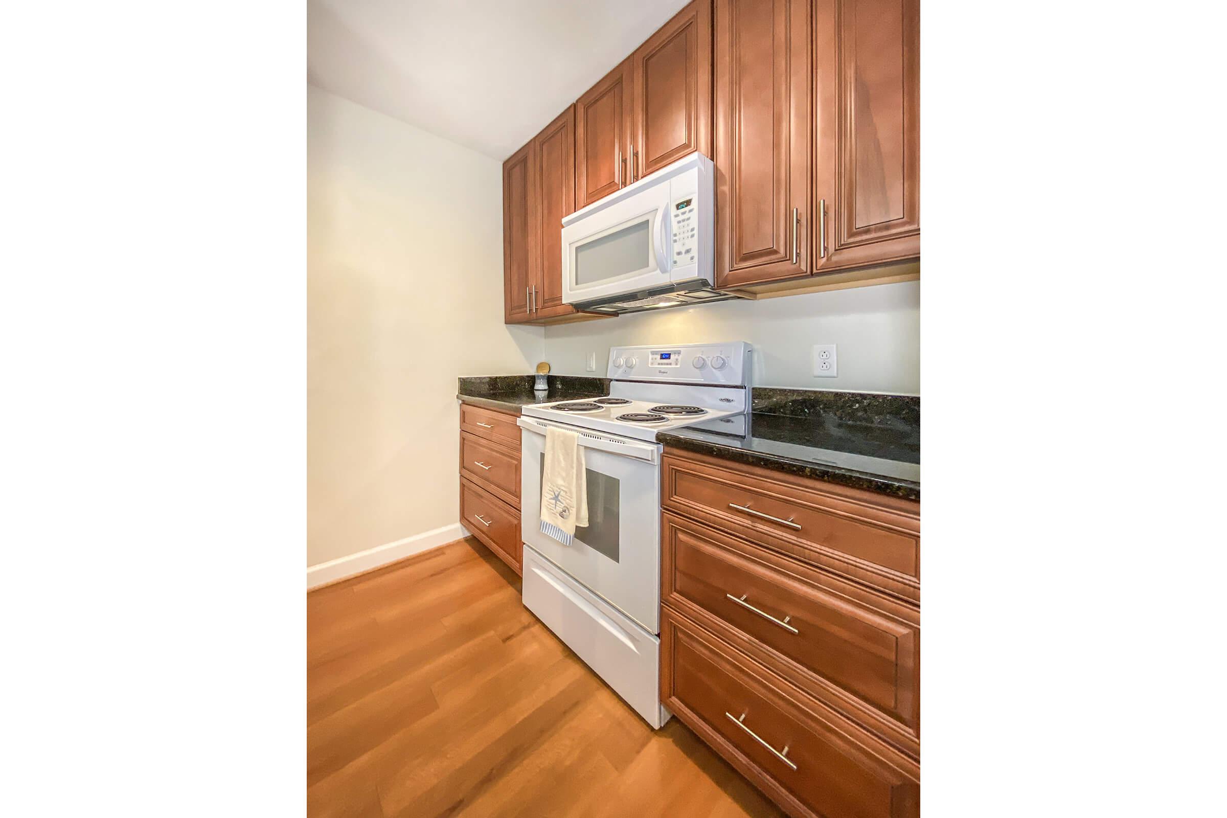 a stove top oven sitting inside of a kitchen