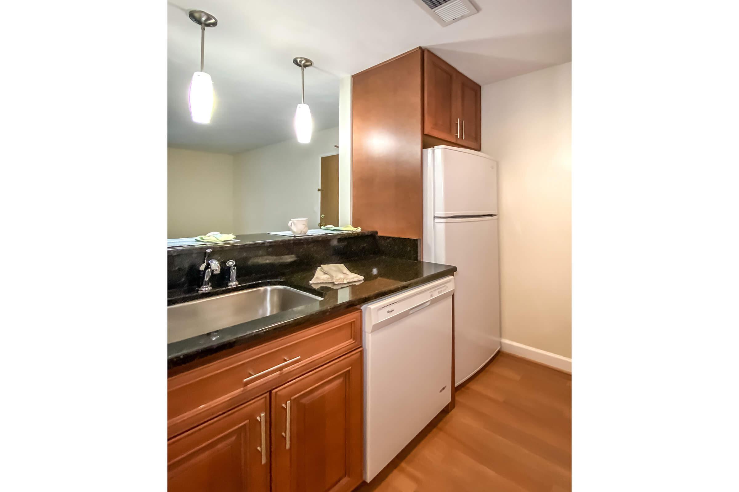 a kitchen with a sink and a mirror