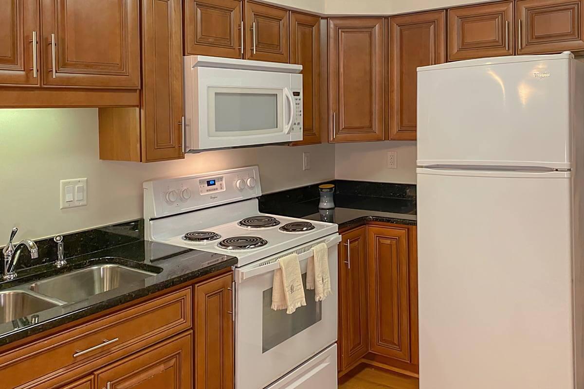 a kitchen with stainless steel appliances and wooden cabinets