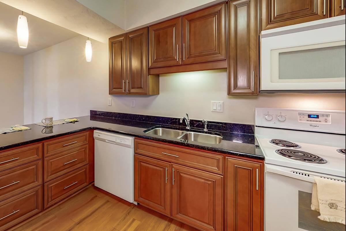 a kitchen with stainless steel appliances and wooden cabinets