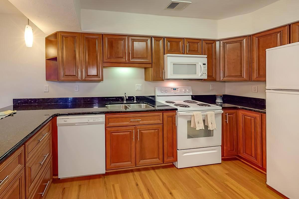 a kitchen with stainless steel appliances and wooden cabinets