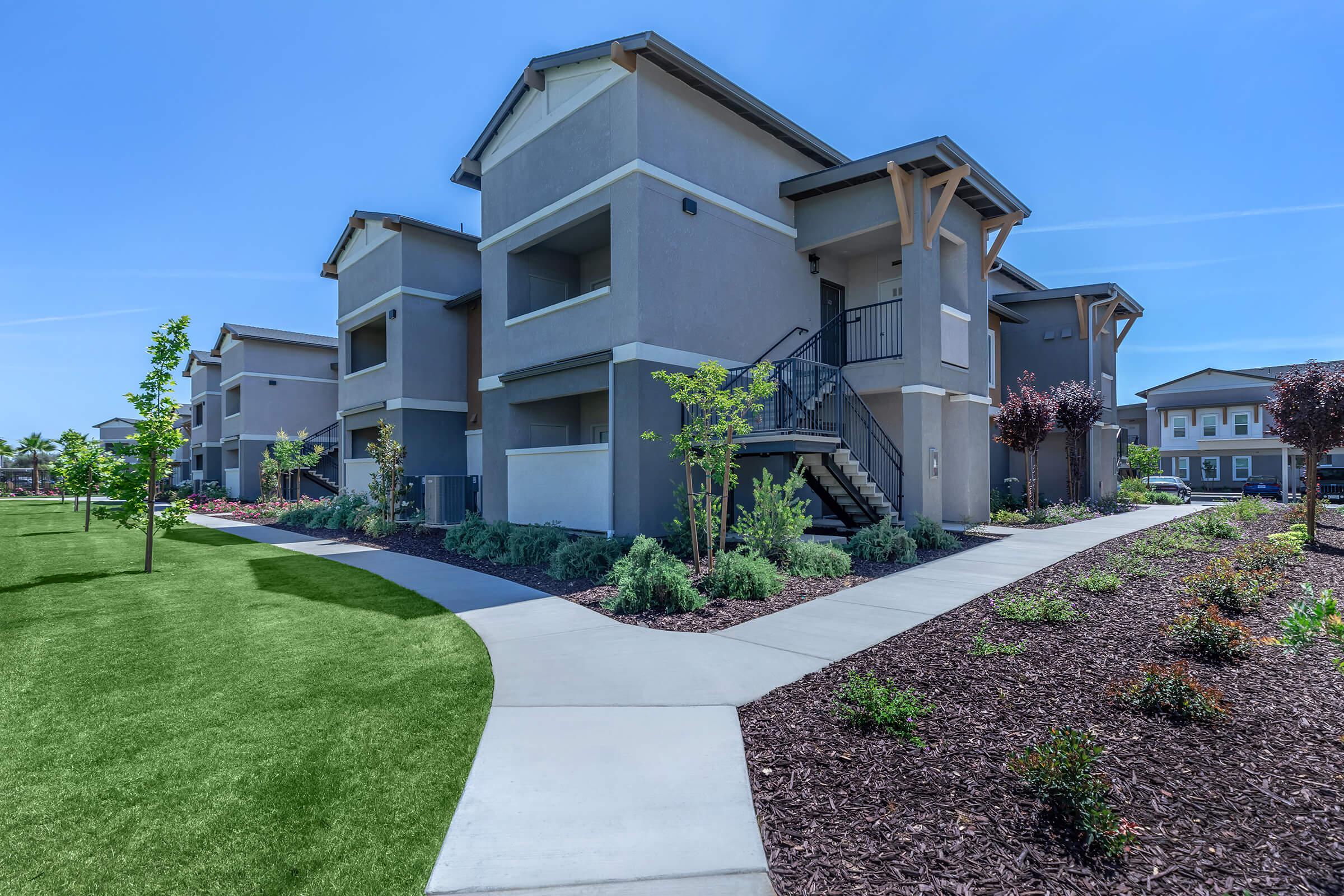 a house with a lawn in front of a building