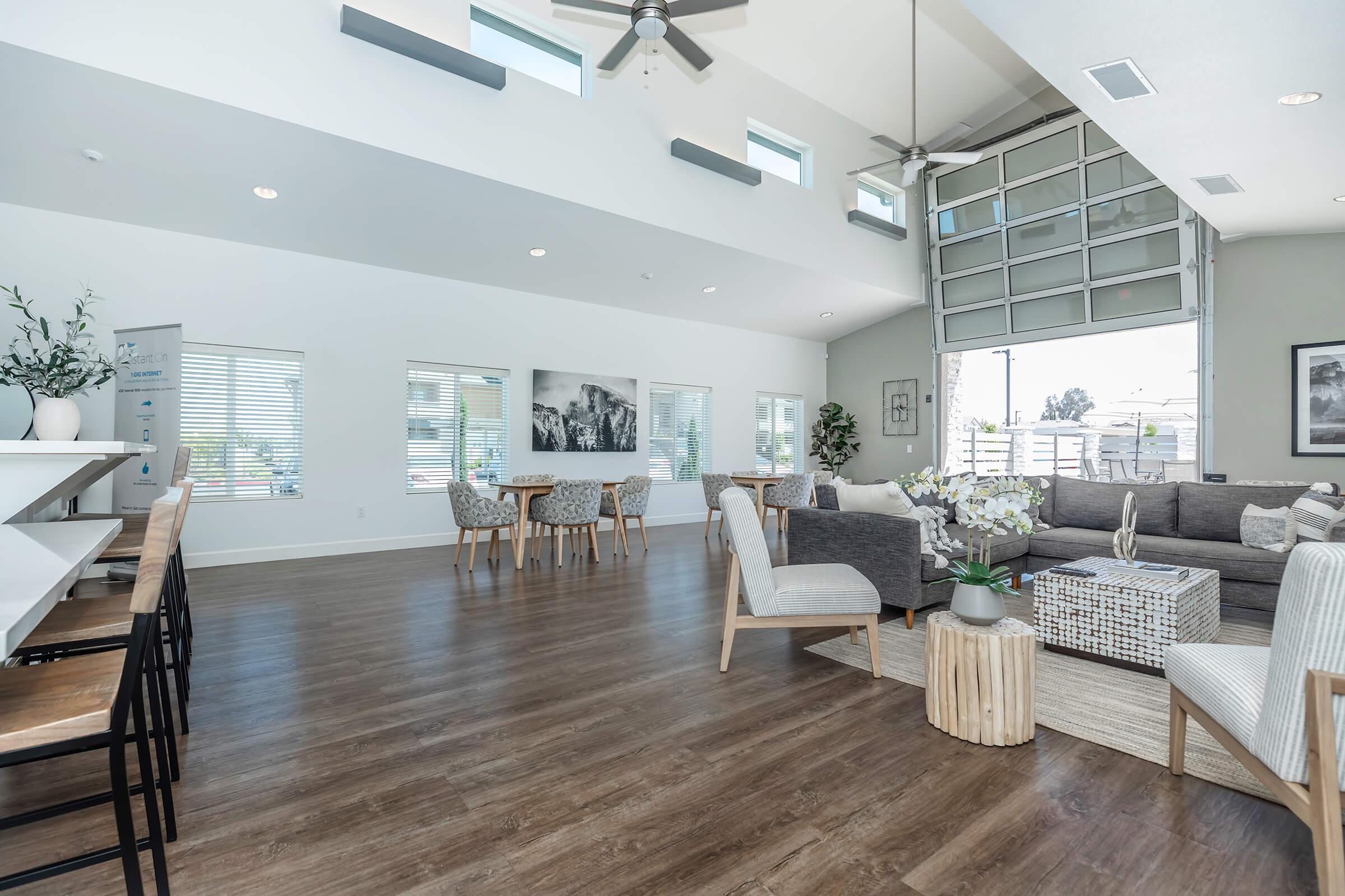 a living room filled with furniture and a large window