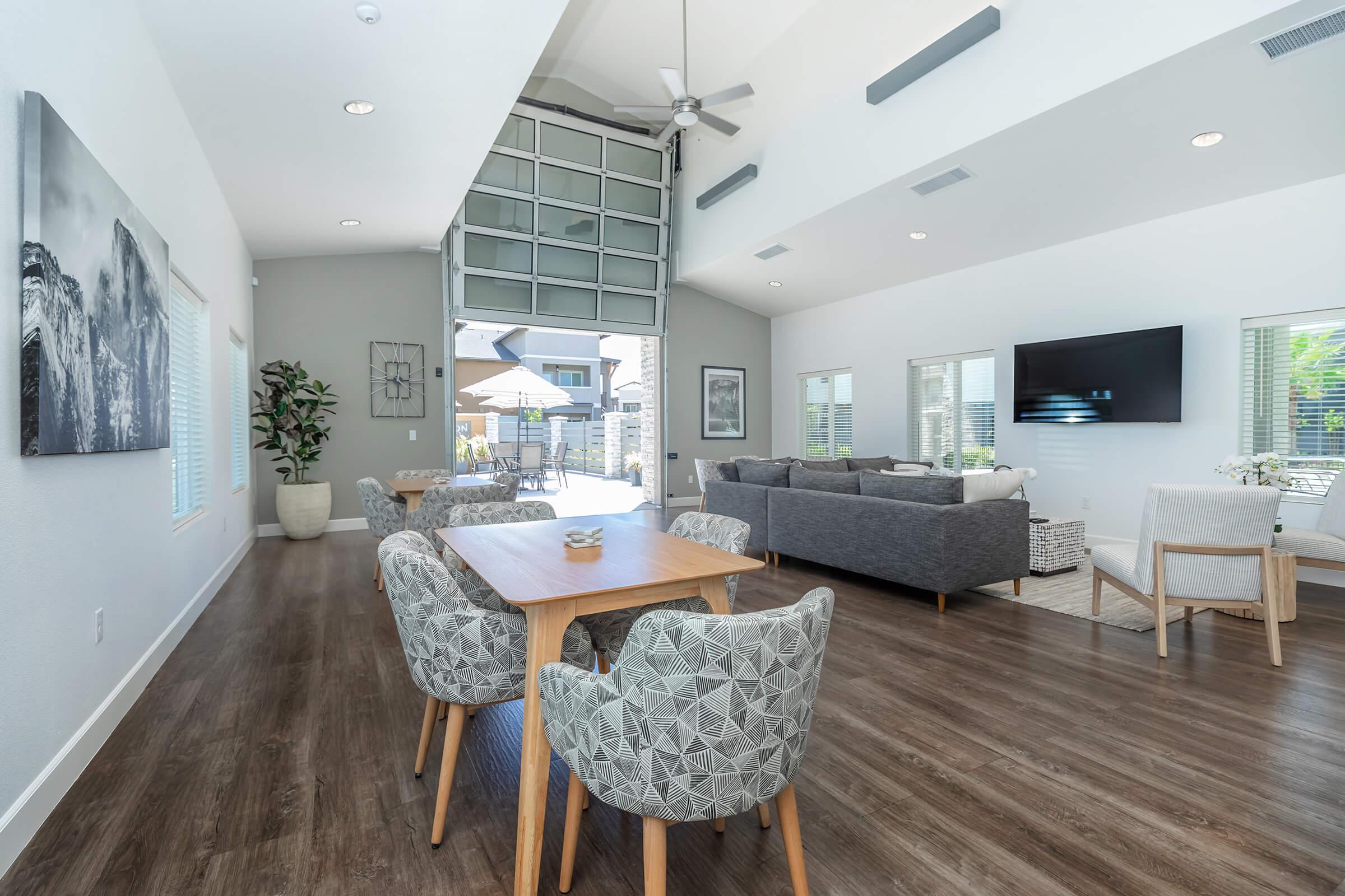 a living room filled with furniture and a large window