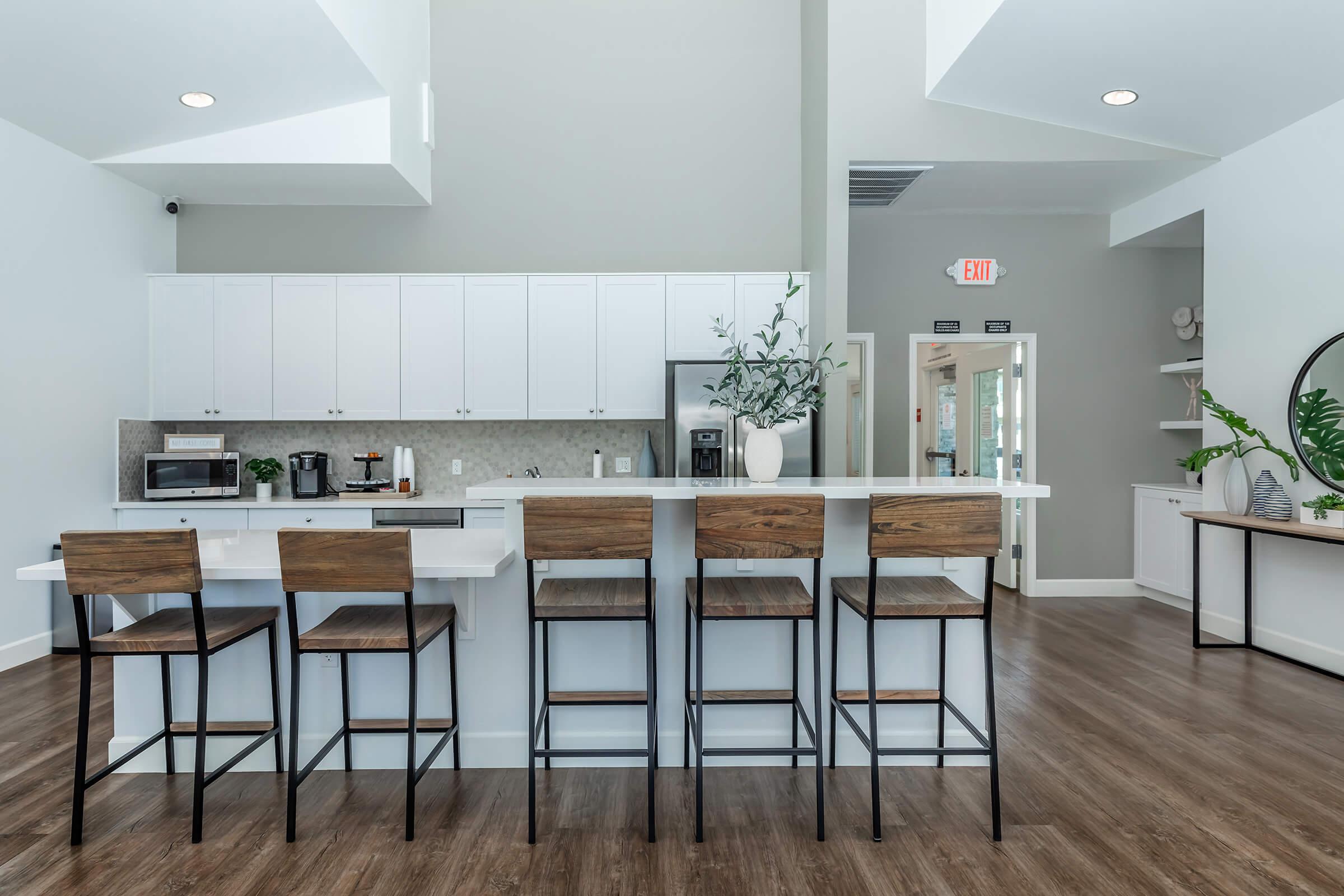 a kitchen with a table and chairs in a room