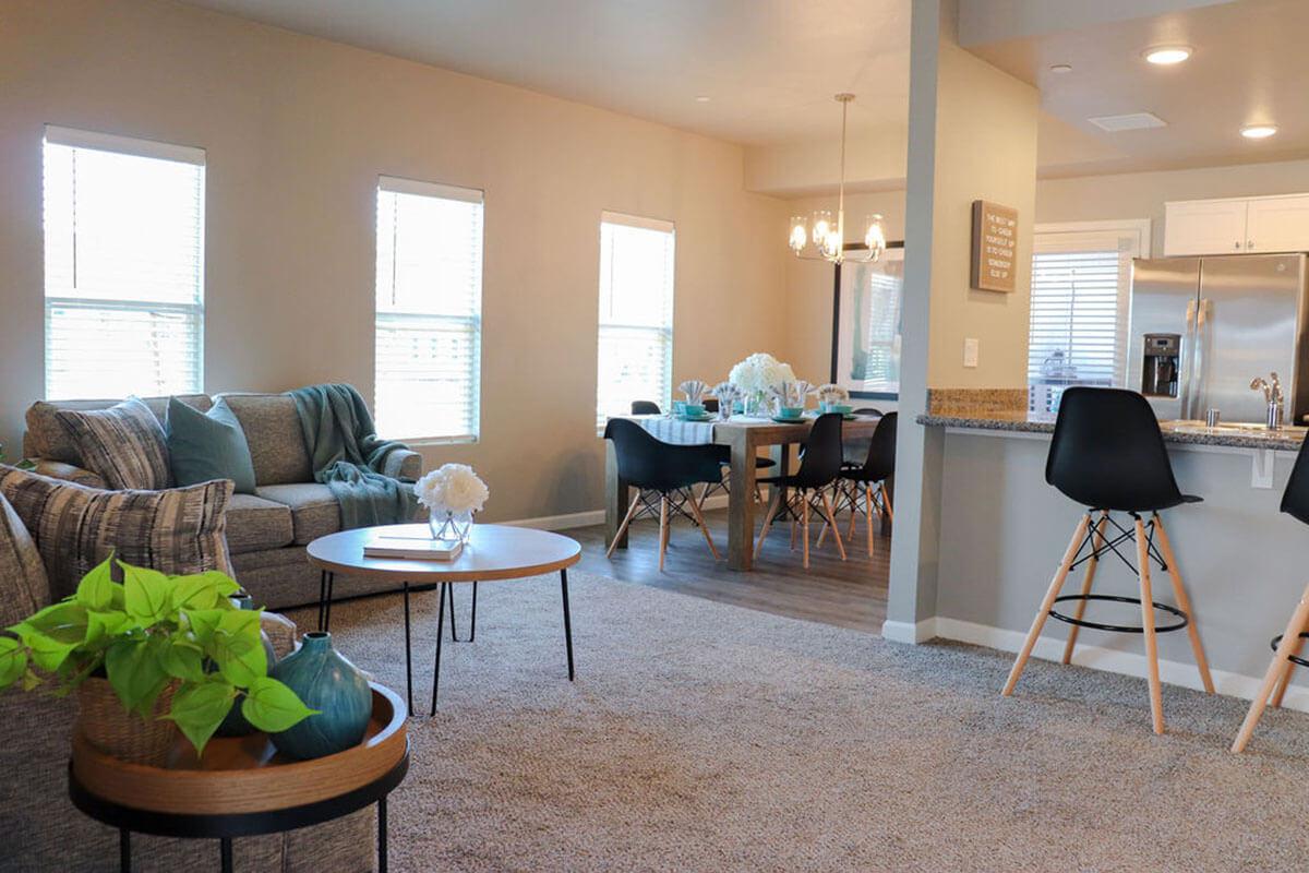 a living room filled with furniture and a large window