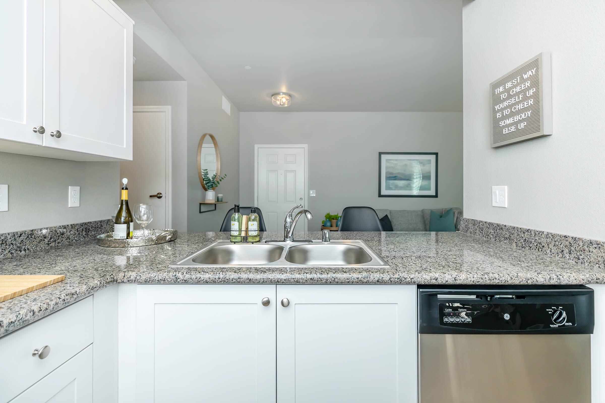 a kitchen with a stove a sink and a microwave