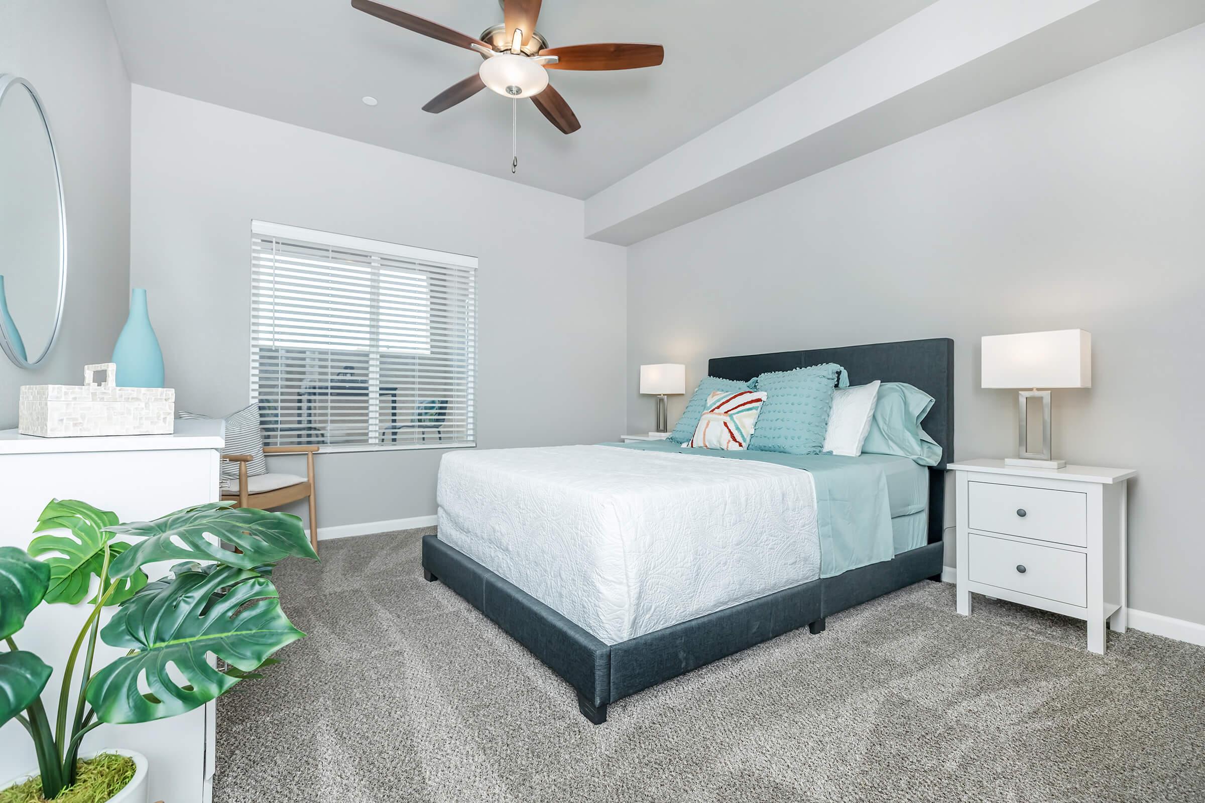 a bedroom with a bed and desk in a room