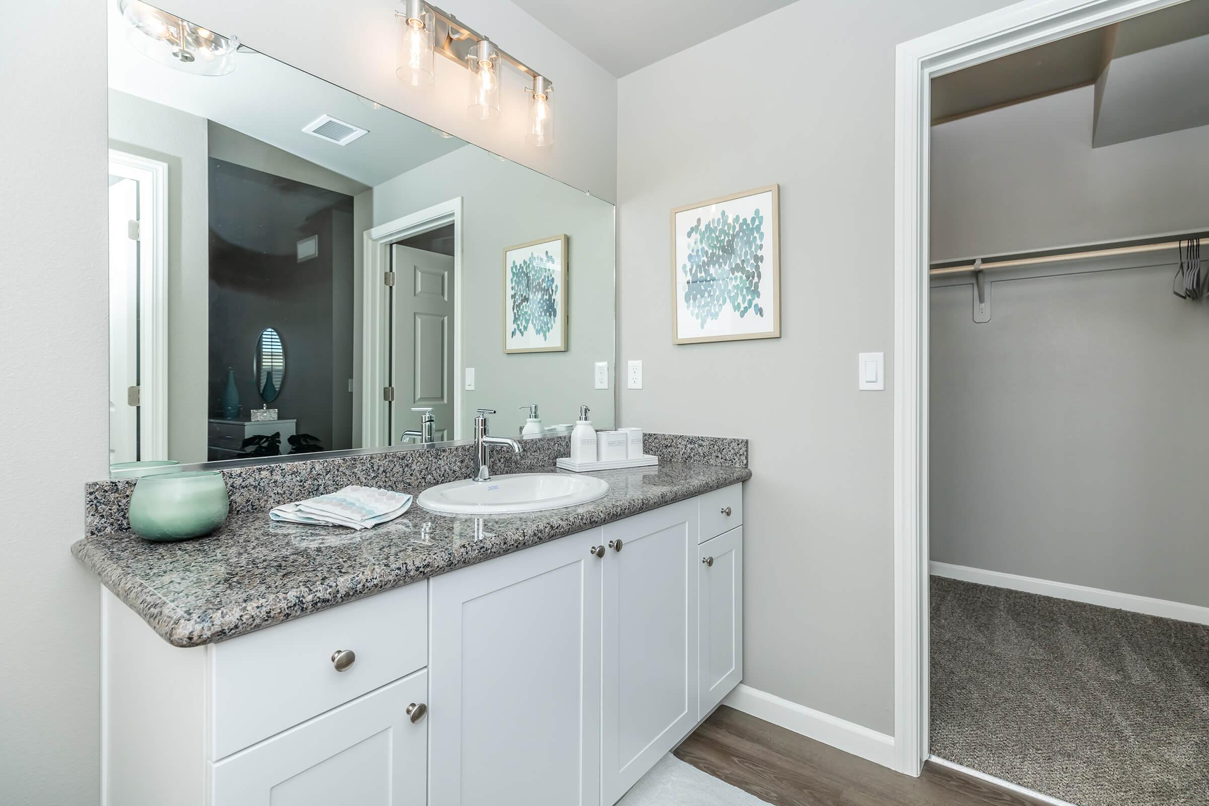 a kitchen with a sink and a mirror