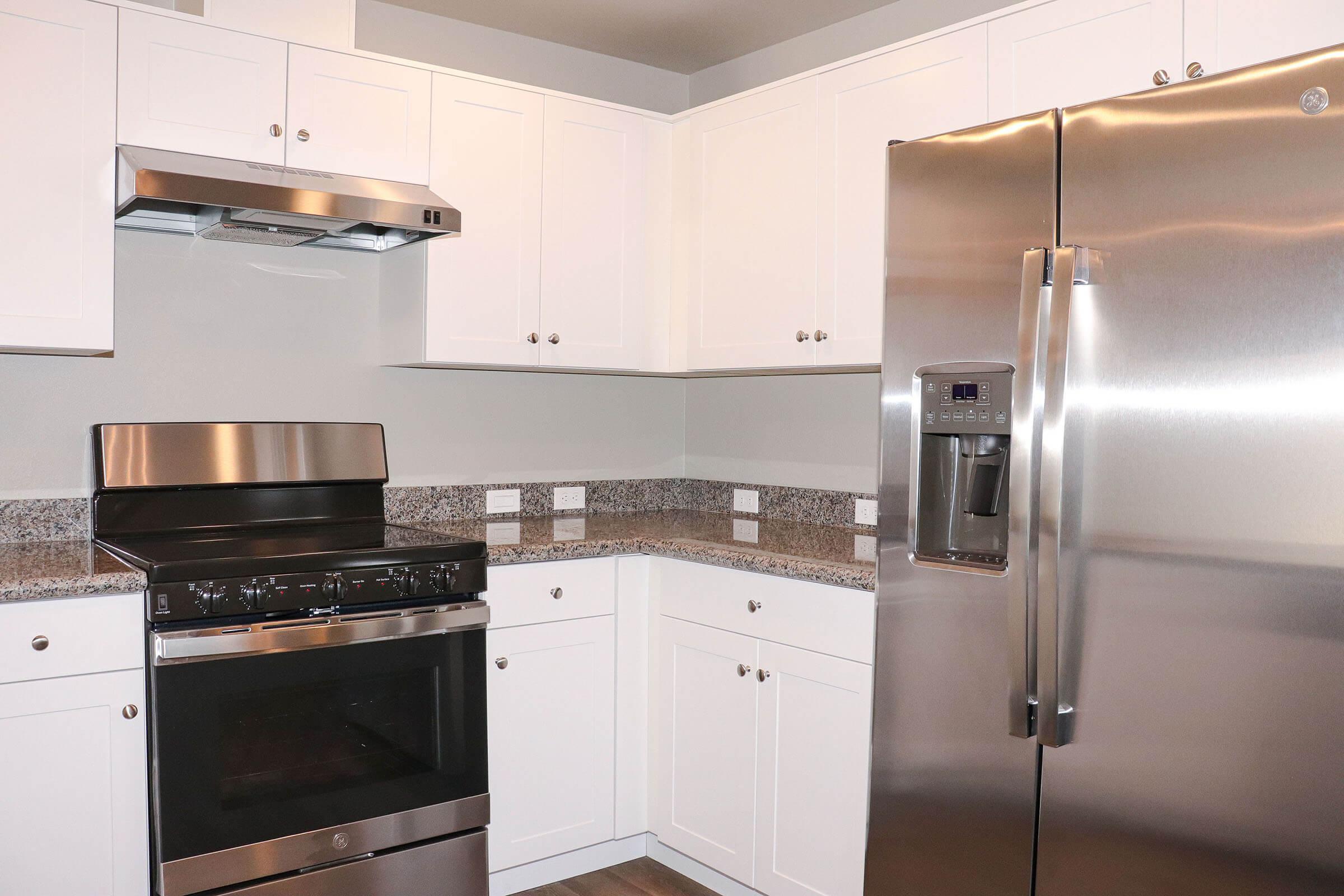 a stove top oven sitting inside of a kitchen