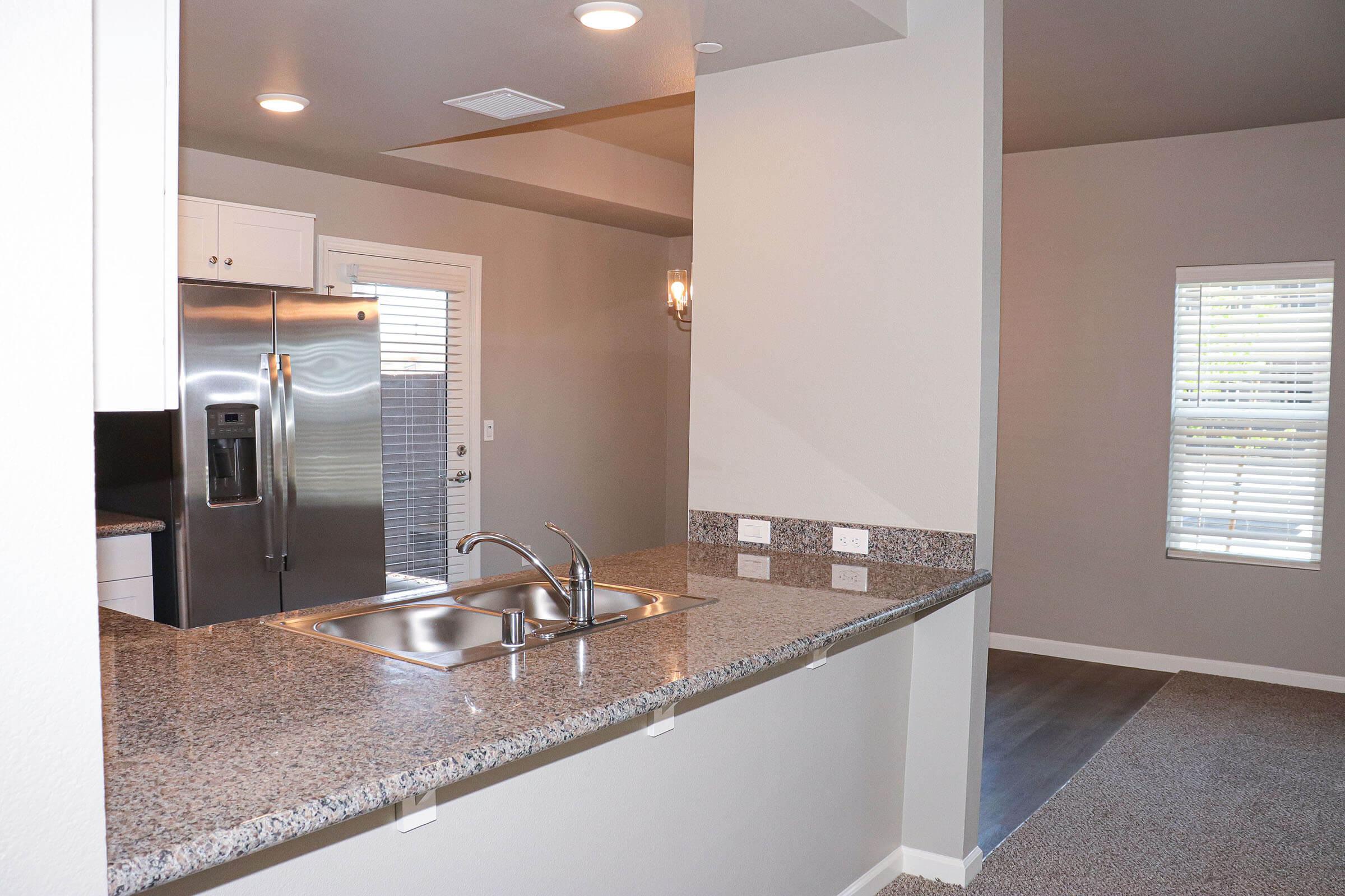 a kitchen with a sink and a mirror