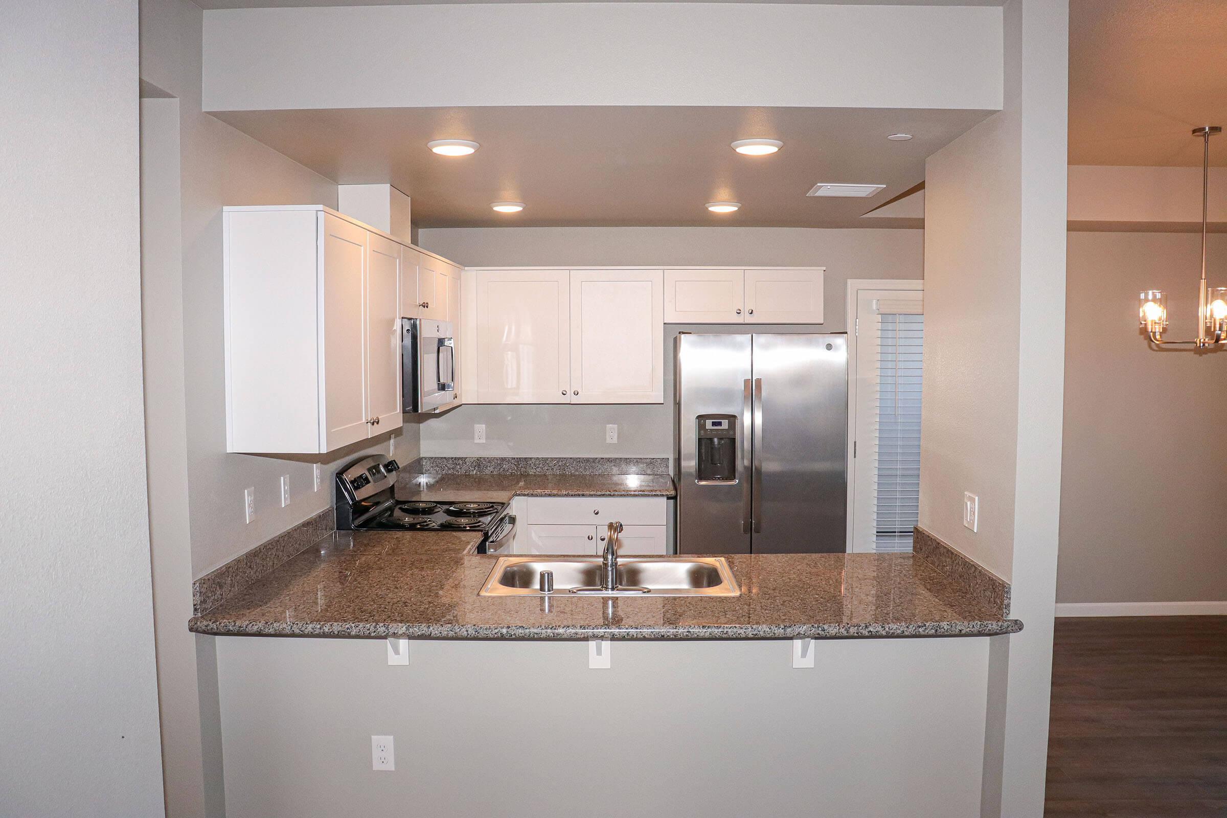 a kitchen with a sink and a mirror