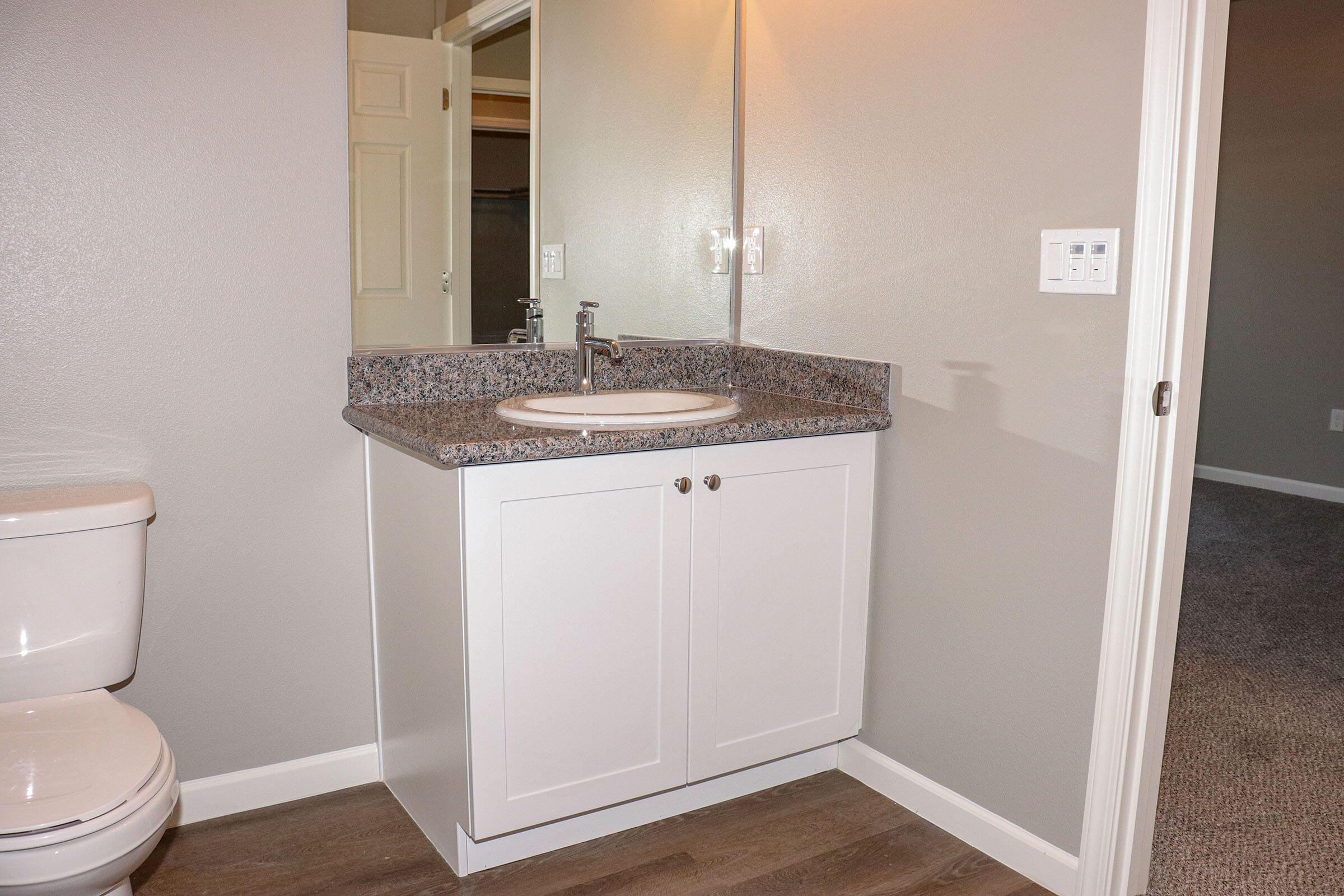 a kitchen with a sink and a mirror