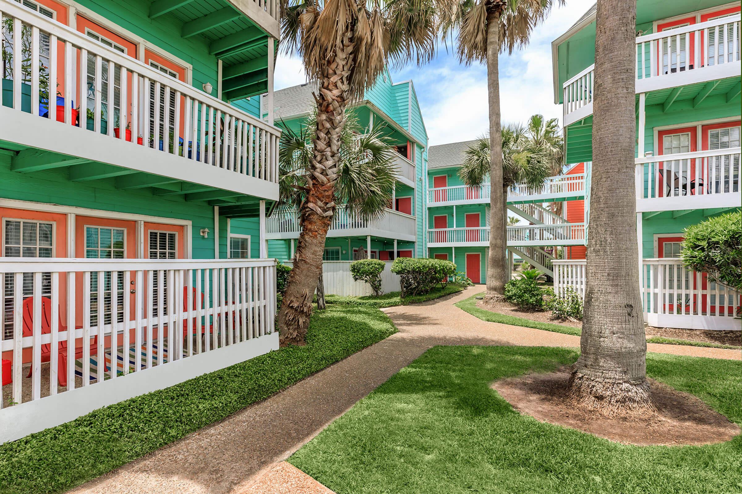 a house with a fence in front of a building