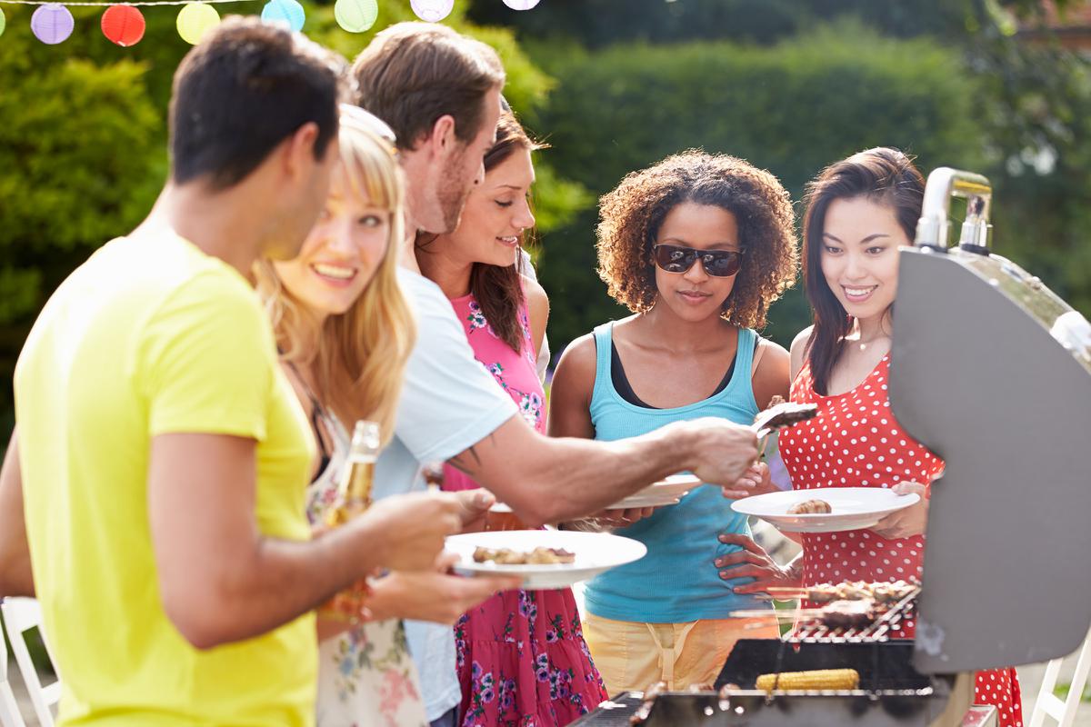 a group of people looking at a birthday cake