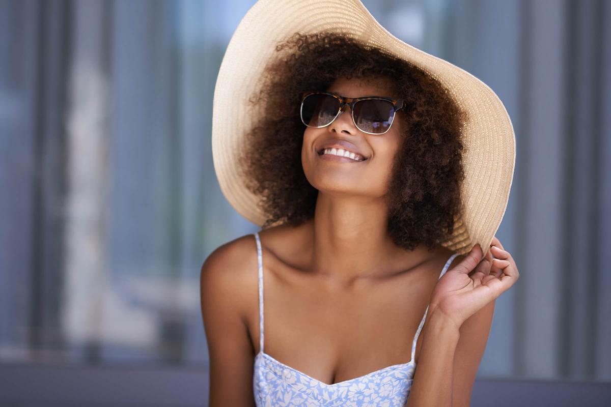 a person wearing a hat and sunglasses